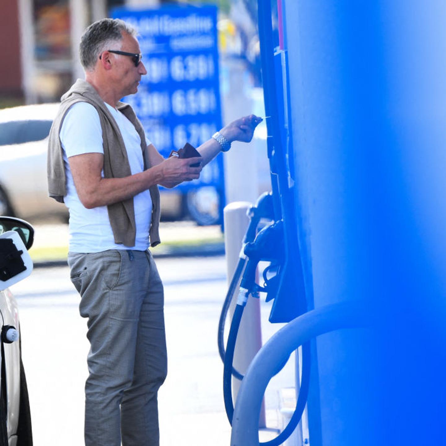 A customer uses a credit card to pump gas at a Mobil gas station in Los Angeles on April 28, 2022. High fuel prices have contributed to windfall profits for fossil fuel companies.