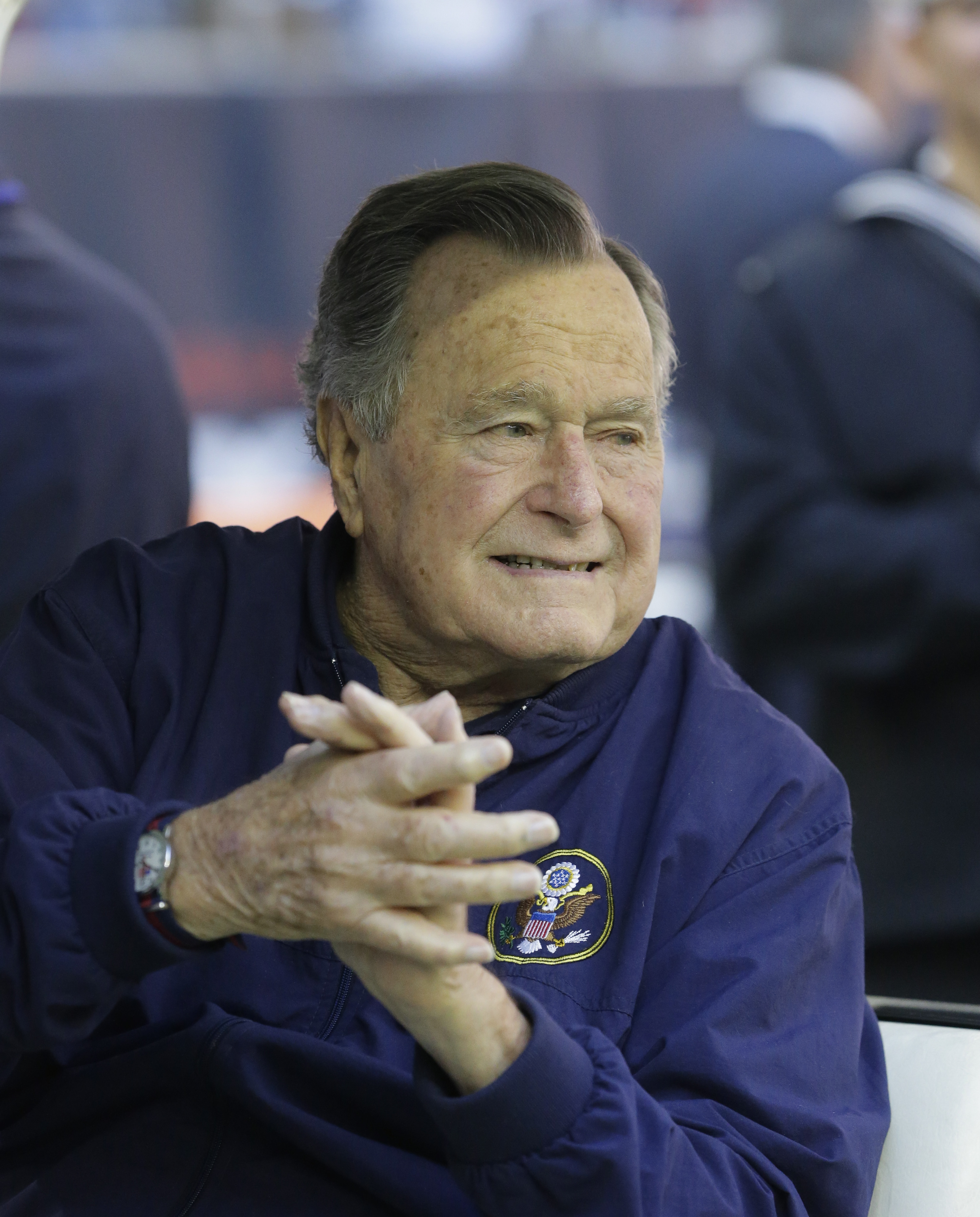 Former president George H. W. Bush attends an NFL football game between the Houston Texans an Cincinnati Bengals on Nov. 23, 2014, in Houston.