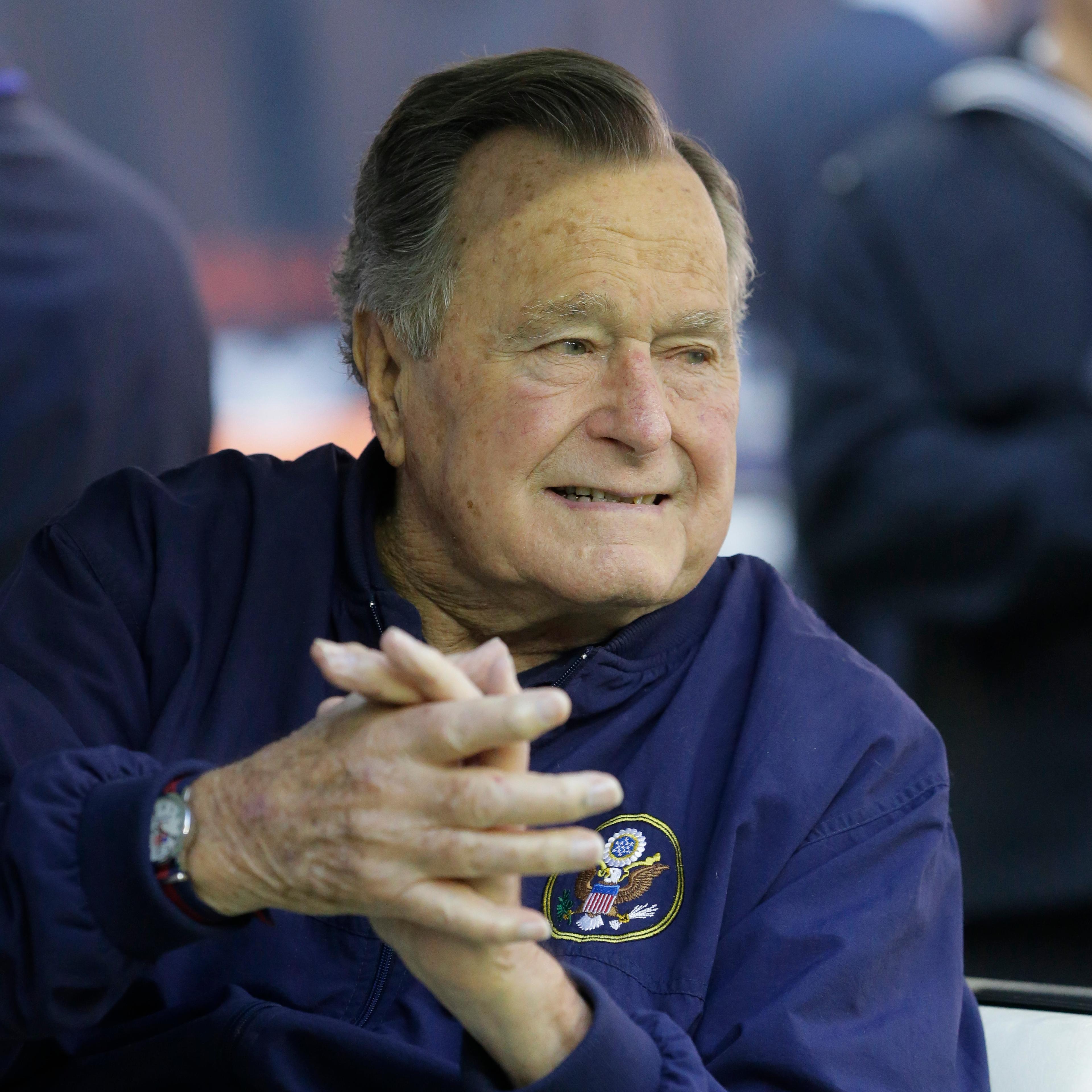 Former president George H. W. Bush attends an NFL football game between the Houston Texans an Cincinnati Bengals on Nov. 23, 2014, in Houston.