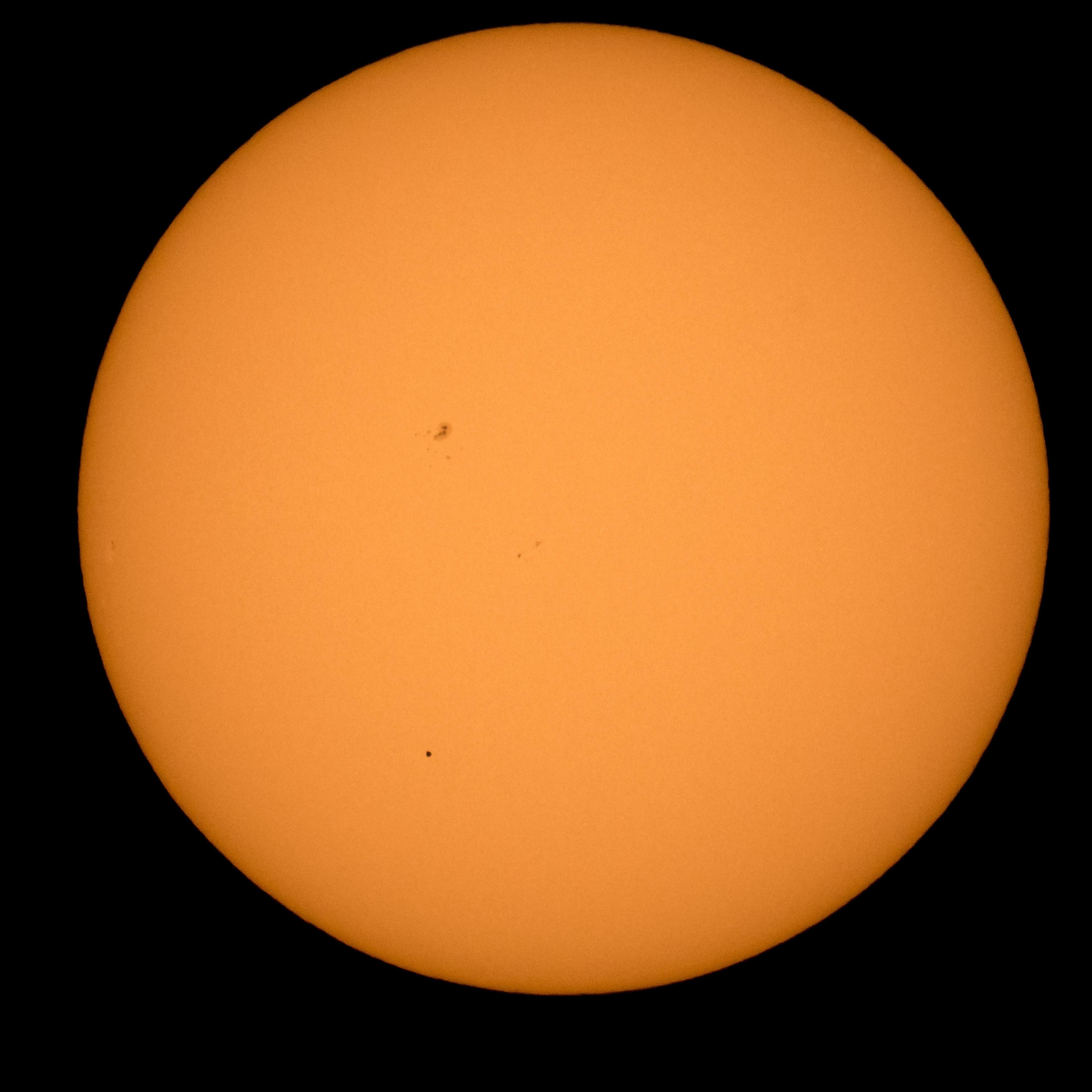 The planet Mercury is seen in silhouette, lower third of image, as it transits across the face of the sun as viewed from Boyertown, PA, May 9, 2016.