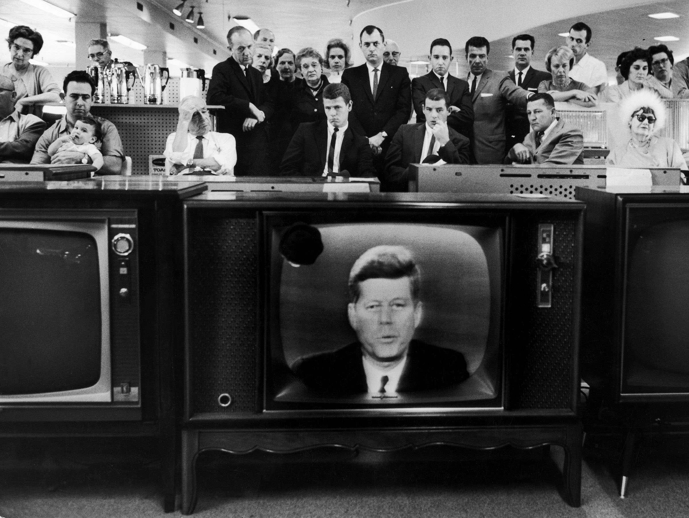People watching Pres. John F. Kennedy's TV announc