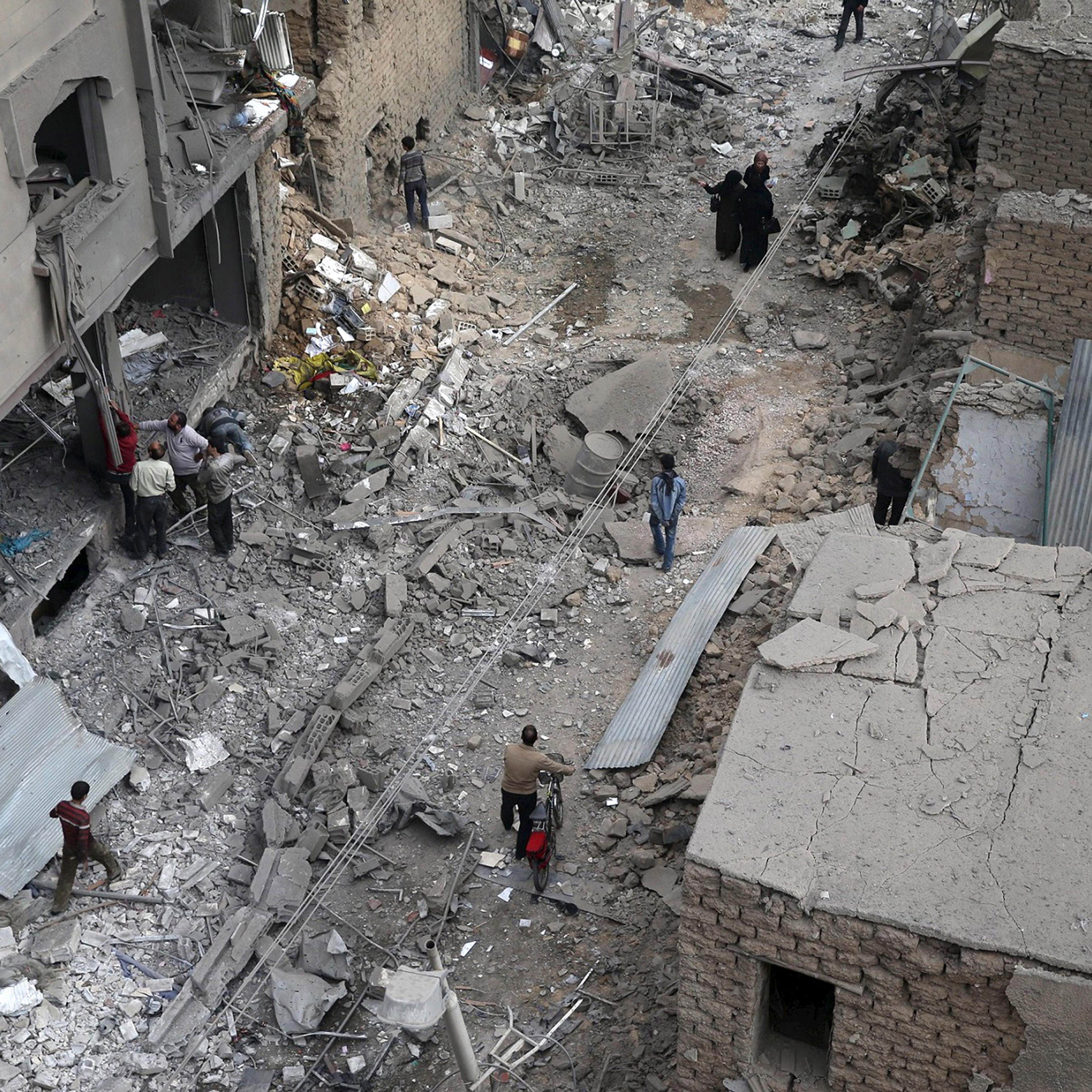 Residents inspect damage from what activists said was an airstrike by forces loyal to Syria's President Bashar al-Assad on the main field hospital in the town of Douma, eastern Ghouta in Damascus October 29, 2015. REUTERS/Bassam Khabieh TPX IMAGES OF THE