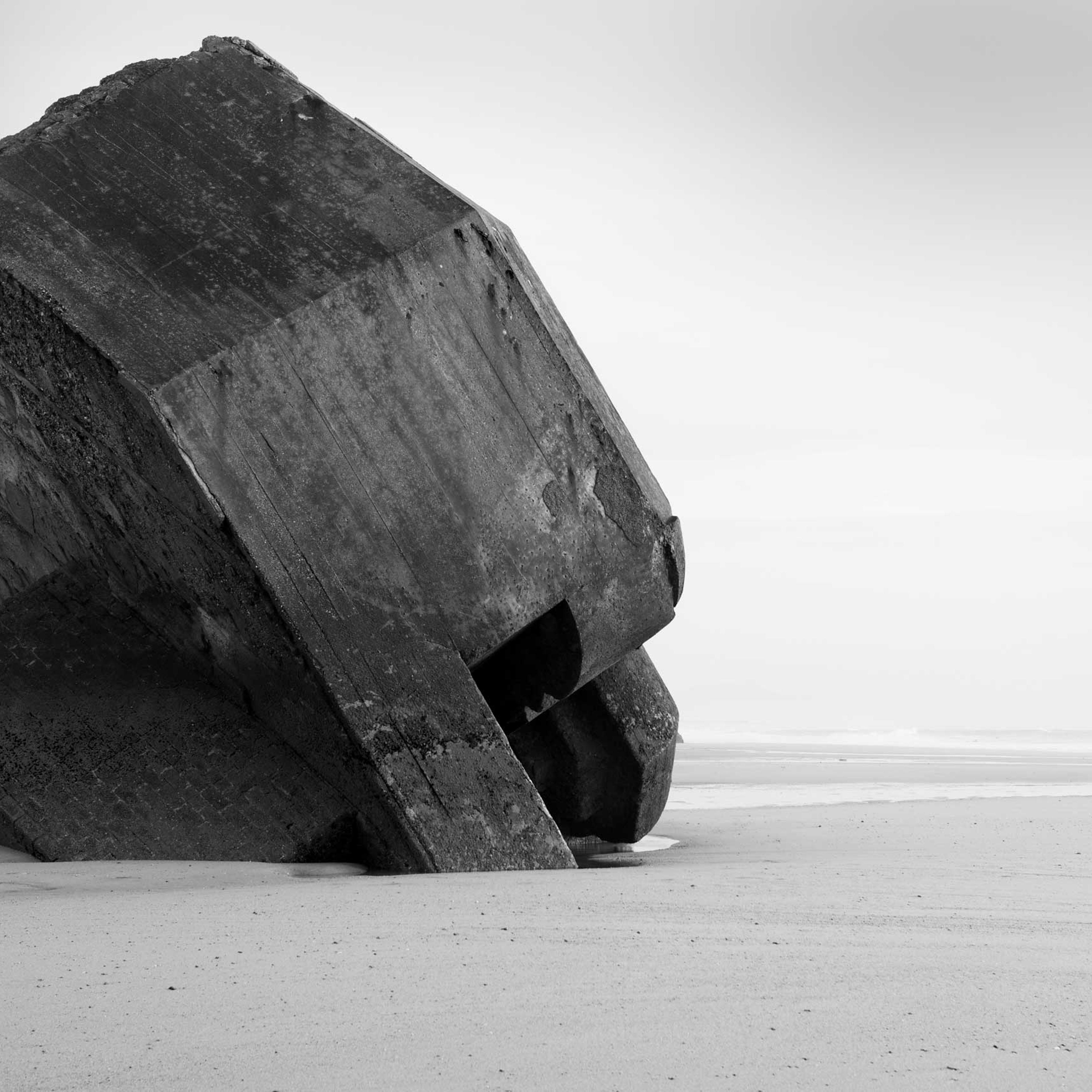 The remnants of a concrete defensive structure used by the German Army during World War II juts out of the sand along a beach in nothern France along the route of the Atlantic Wall (Atlantikwall in German).