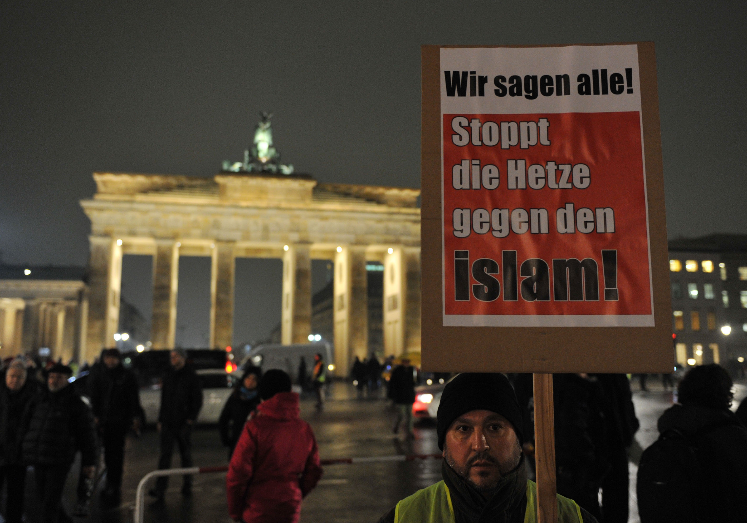 BERLIN, GERMANY - JANUARY 05 :  A man holds a placard reading "We all say, stop the hate against Islam" during a protest against Pegida (Patriotische Europaeer Gegen die Islamisierung des Abendlandes) movement in Berlin, Germany on January 05, 2015.  (Ph