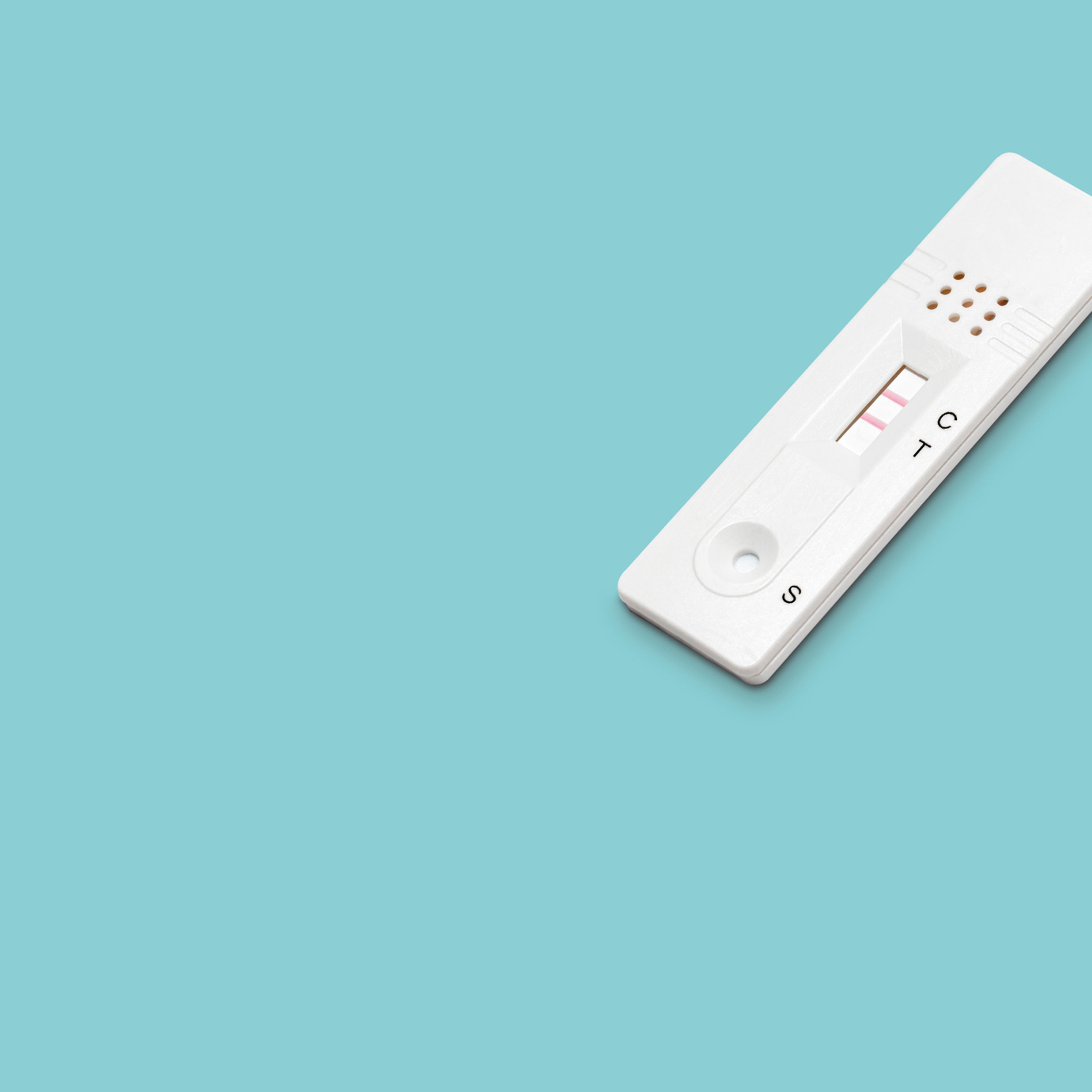 Positive Antigen rapid test for Covid-19 on a blue background