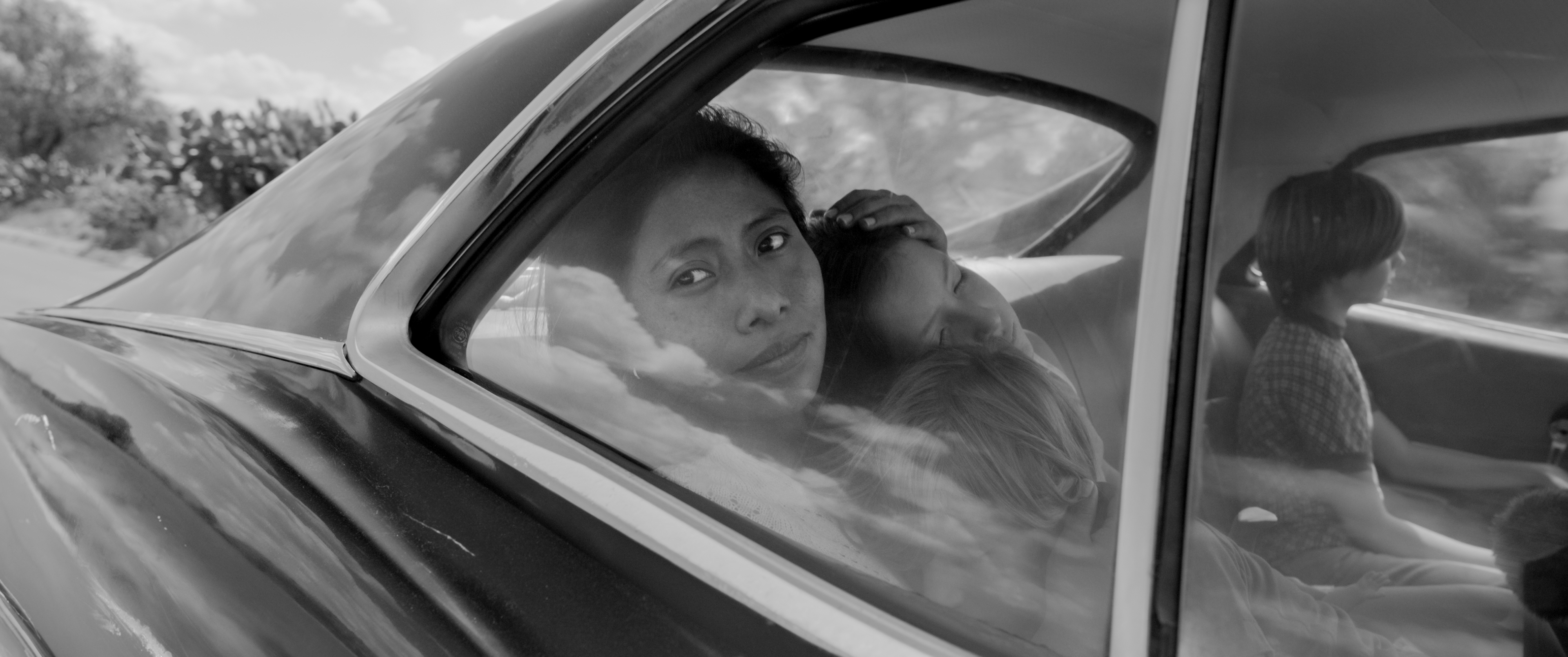 Yalitza Aparicio as Cleo, Marco Graf as Pepe, Carlos Peralta Jacobson as Paco, and Daniela Demesa as Sofi in Roma, written and directed by Alfonso Cuarón.