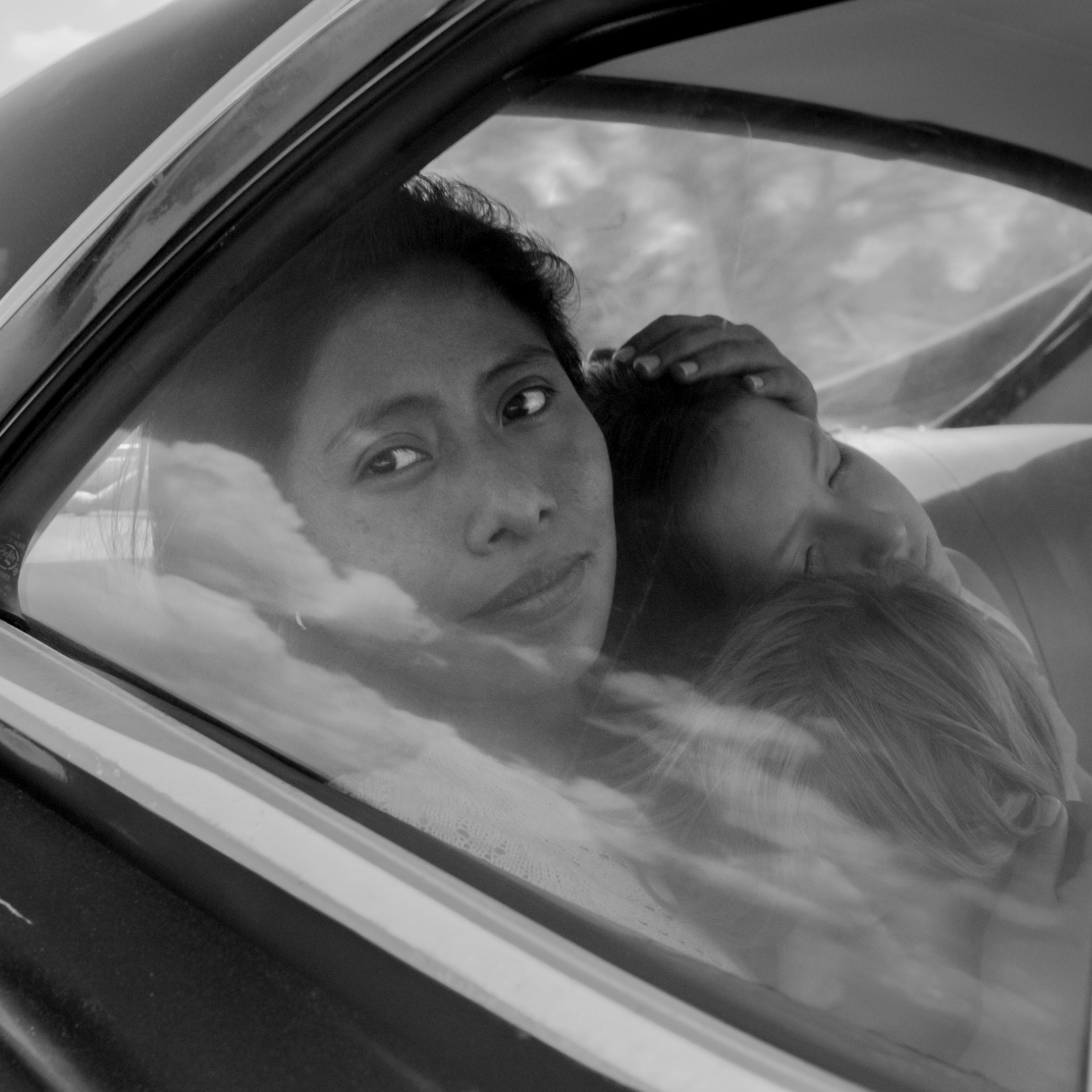 Yalitza Aparicio as Cleo, Marco Graf as Pepe, Carlos Peralta Jacobson as Paco, and Daniela Demesa as Sofi in Roma, written and directed by Alfonso Cuarón.