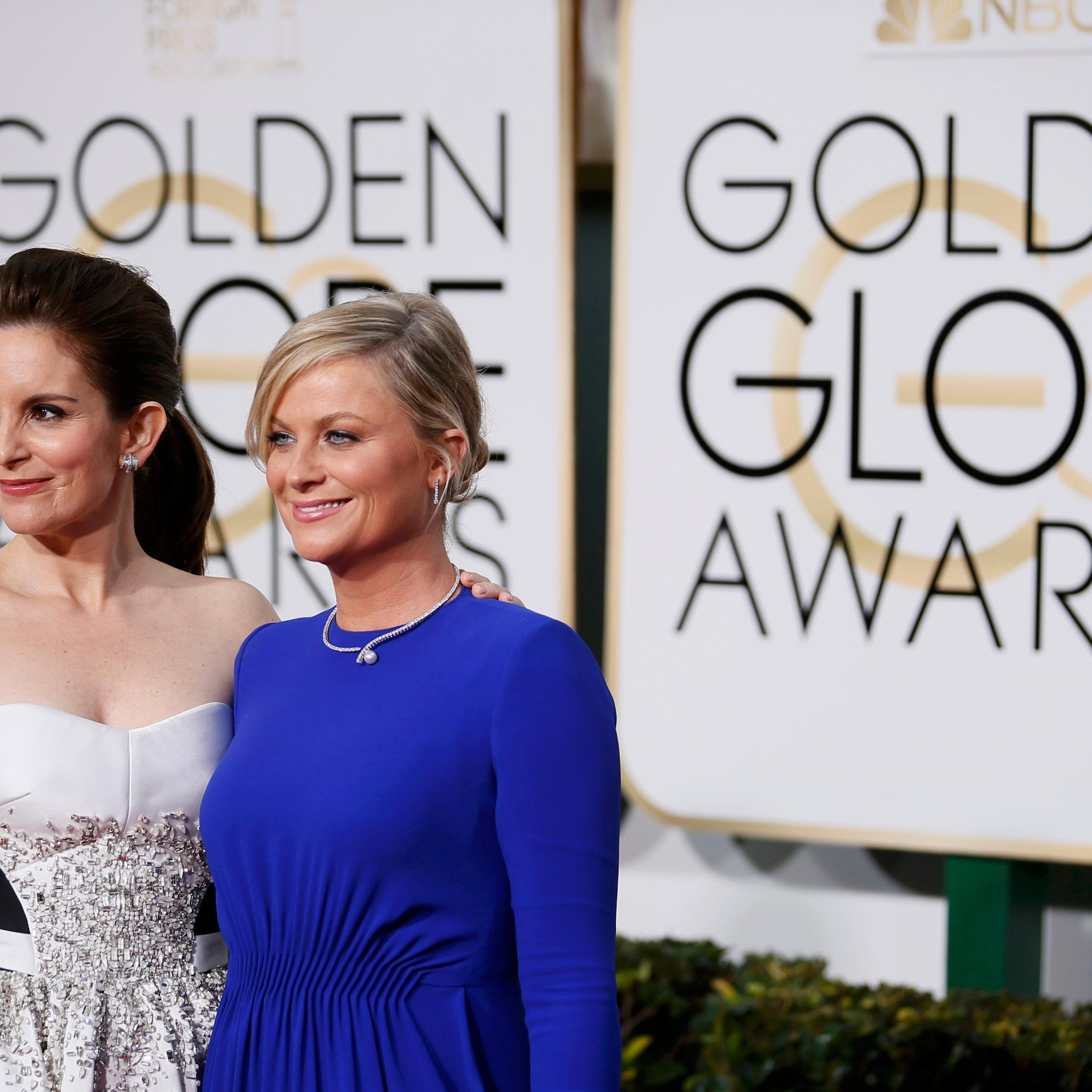 Show hosts Tina Fey and Amy Poehler arrive at the 72nd Golden Globe Awards in Beverly Hills