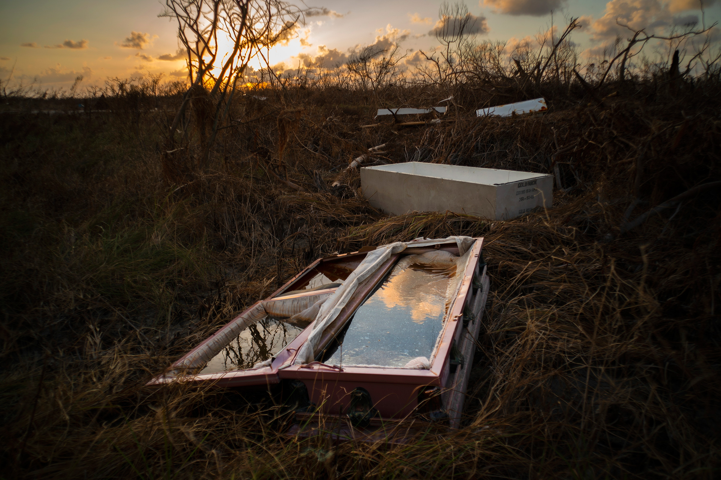 A water-filled coffin lays exposed to the elements in the aftermath of Hurricane Dorian, at the cemetery in Mclean's Town, Grand Bahama, Bahamas, Wednesday Sept. 11, 2019. 