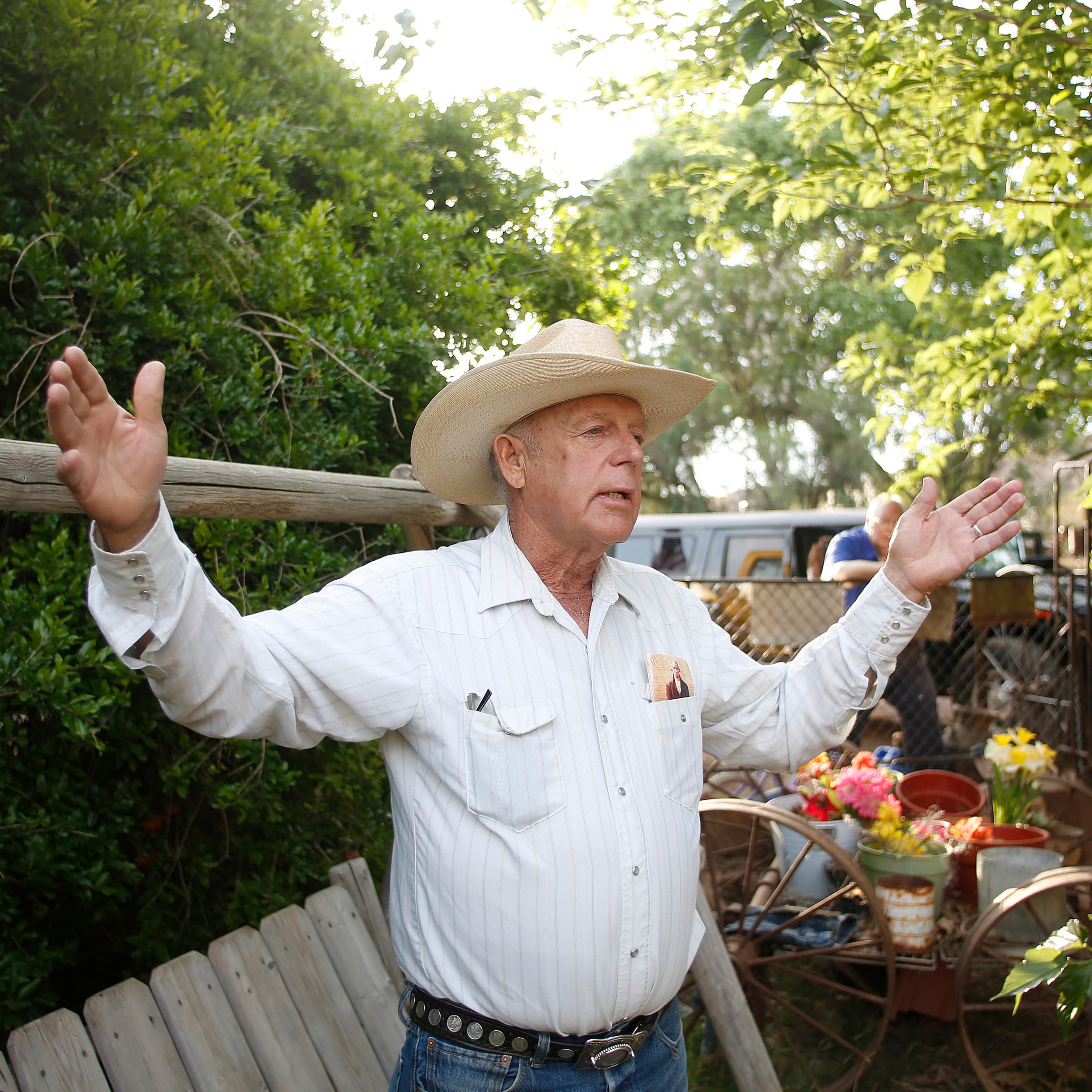 Rancher Cliven Bundy gestures at his home in Bunkerville