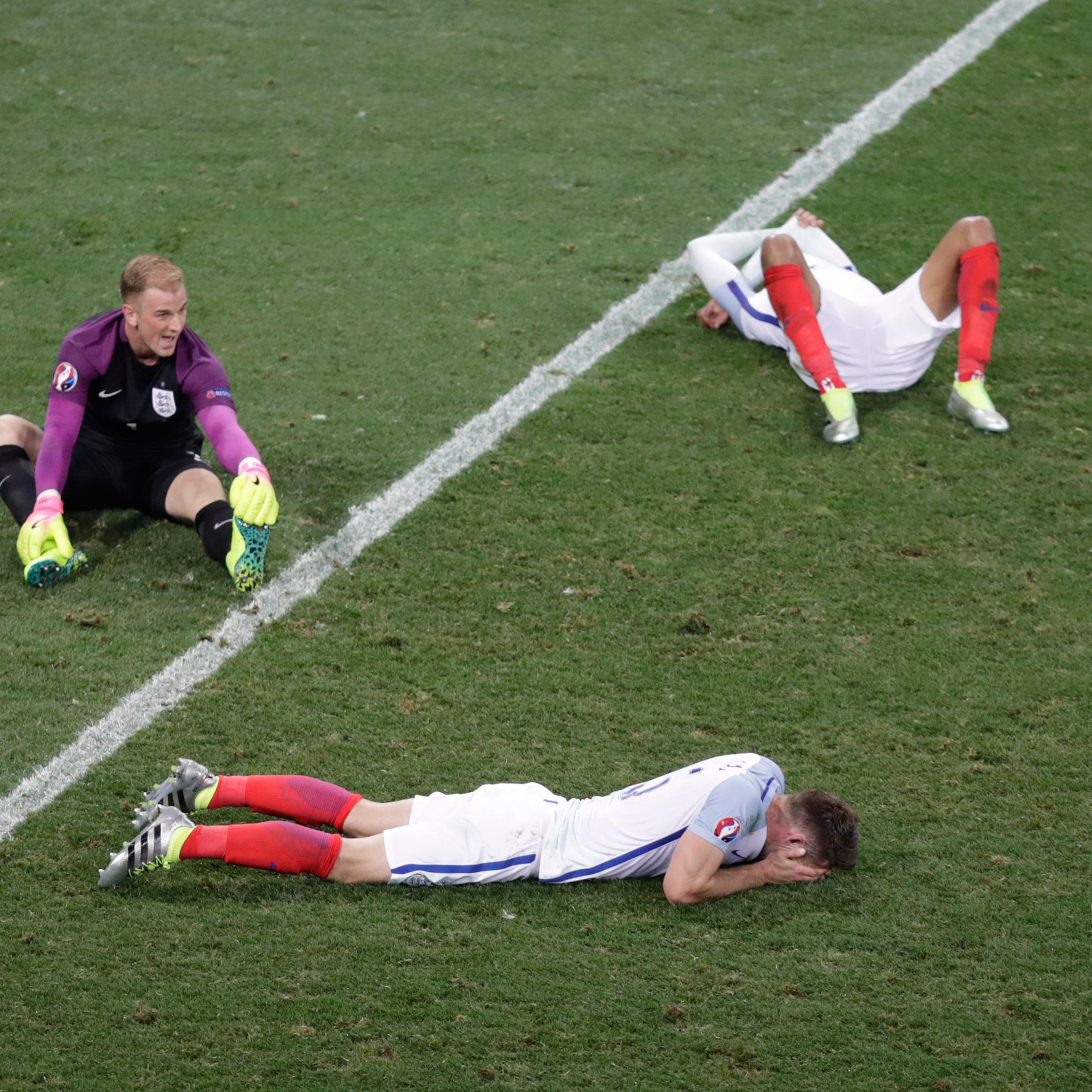 England goalkeeper Joe Hart, left, and two others player lie on the pitch at the end of the Euro 2016 round of 16 soccer match between England and Iceland, at the Allianz Riviera stadium in Nice, France, Monday, June 27, 2016. Iceland won 2-1. (AP Photo/
