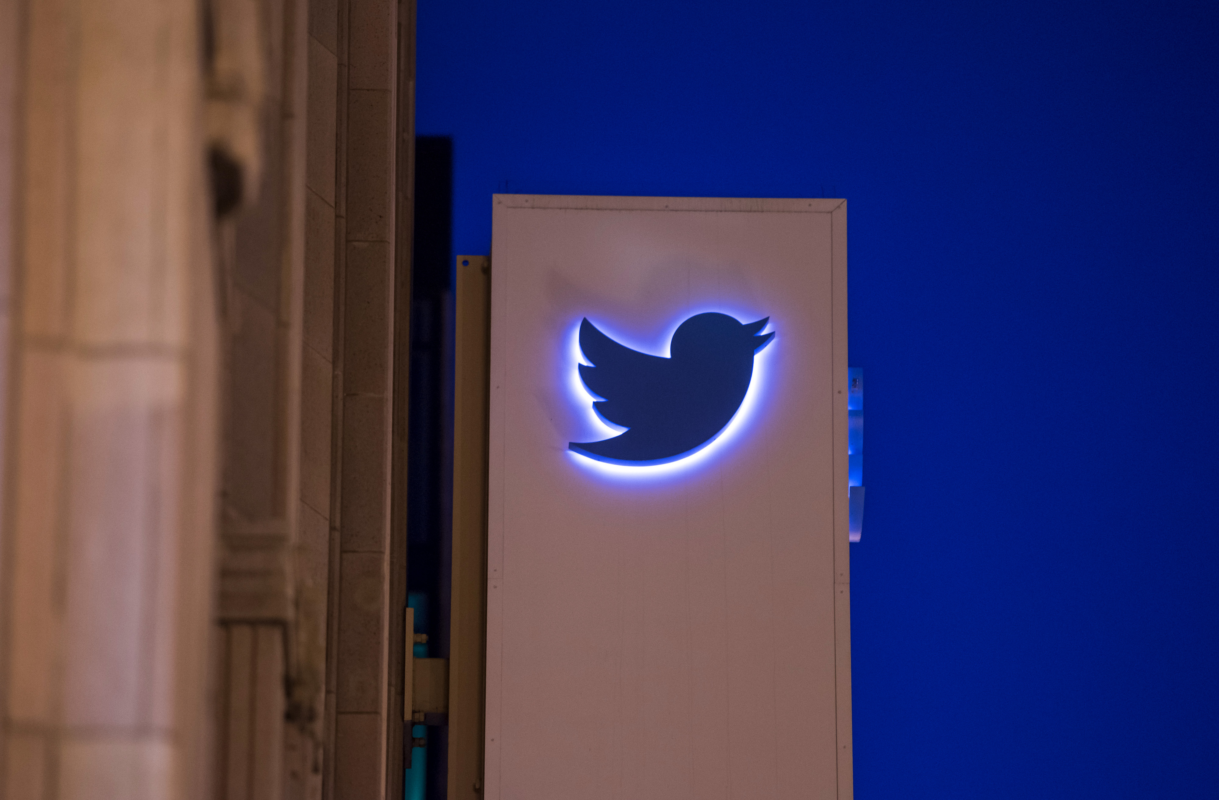 The Twitter Inc. logo and signage is displayed on the facade of the company's headquarters in San Francisco, California, U.S., on Wednesday, Oct. 21, 2015. Twitter Inc. is expected to release earnings figures on Oct. 27. Photographer: David Paul Morris/B