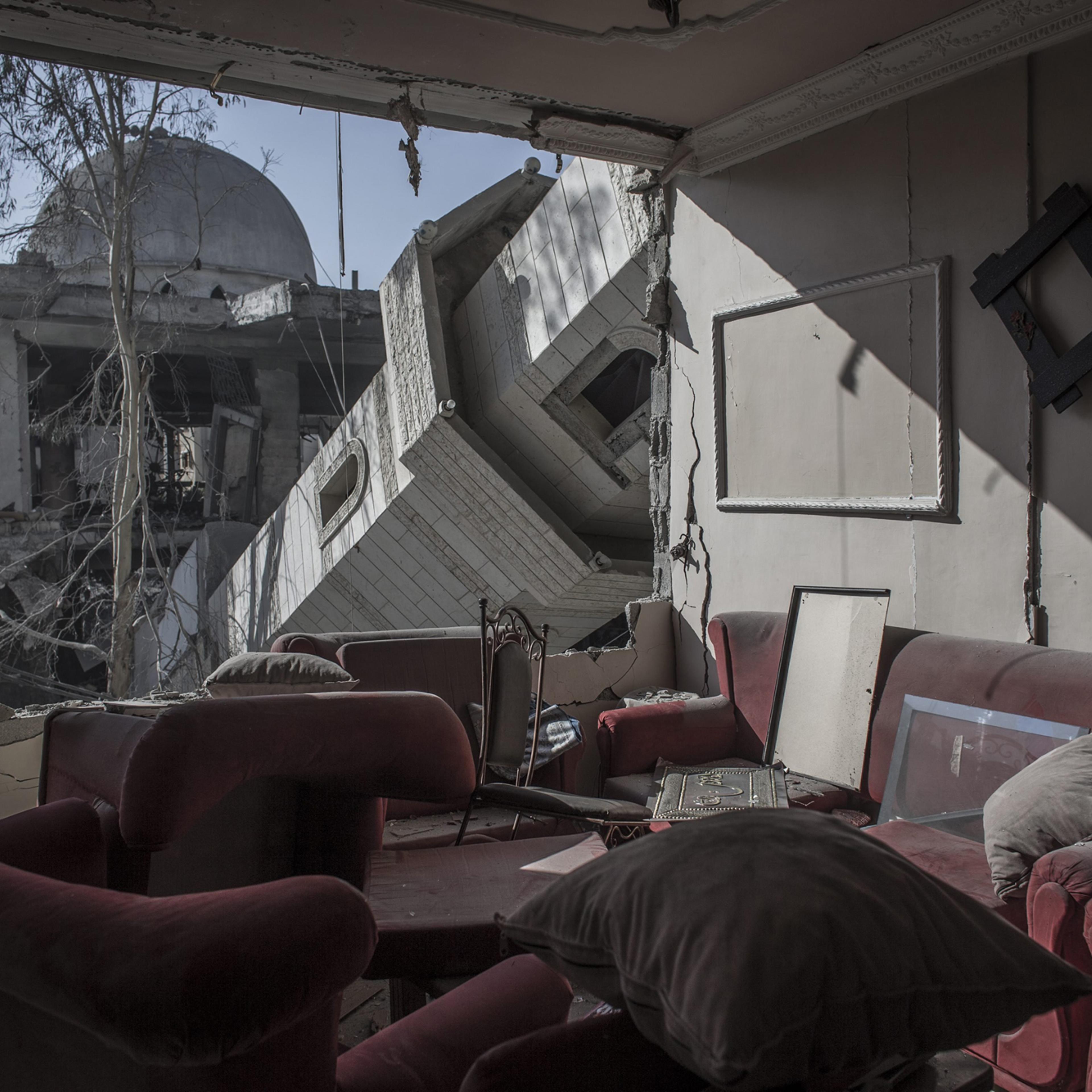 The collapsed minaret of mosque seen from the destroyed living room of a Palestinian family in a building across the street in Gaza City, Gaza Strip, July 30, 2014.