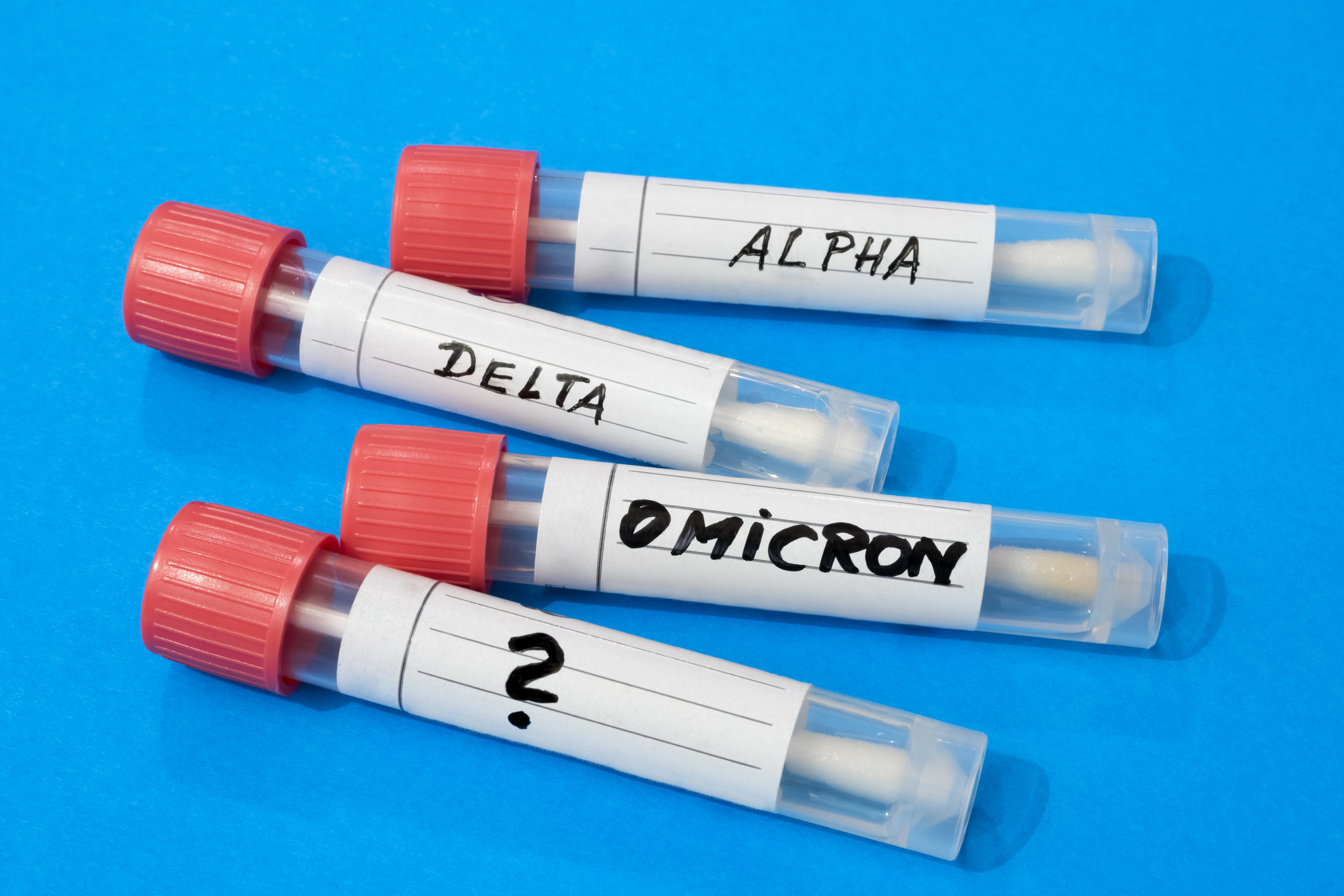 Swab tubes with medical samples on blue background