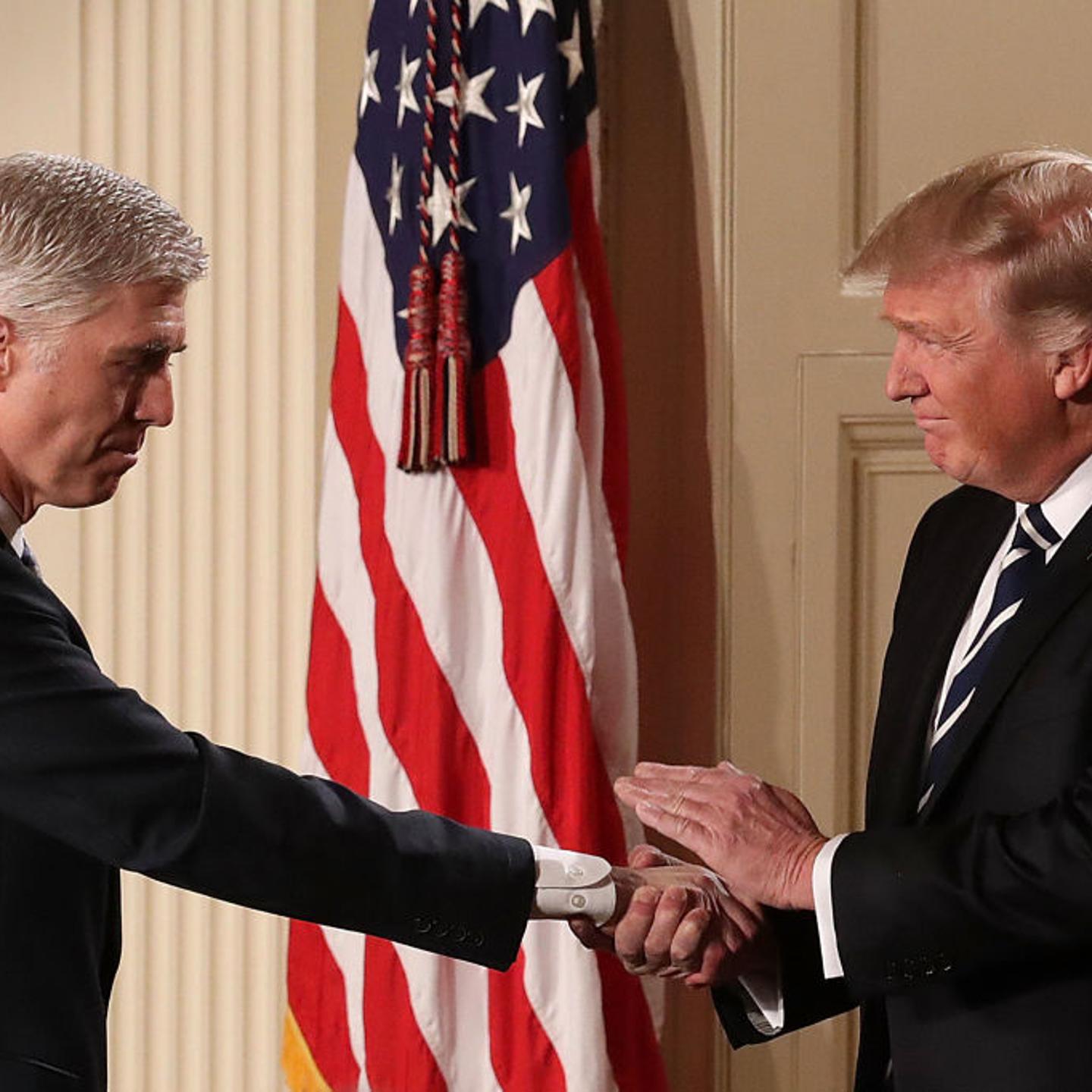 President Donald Trump (R) shakes hands with Judge Neil Gorsuch after nominating him to the Supreme Court.