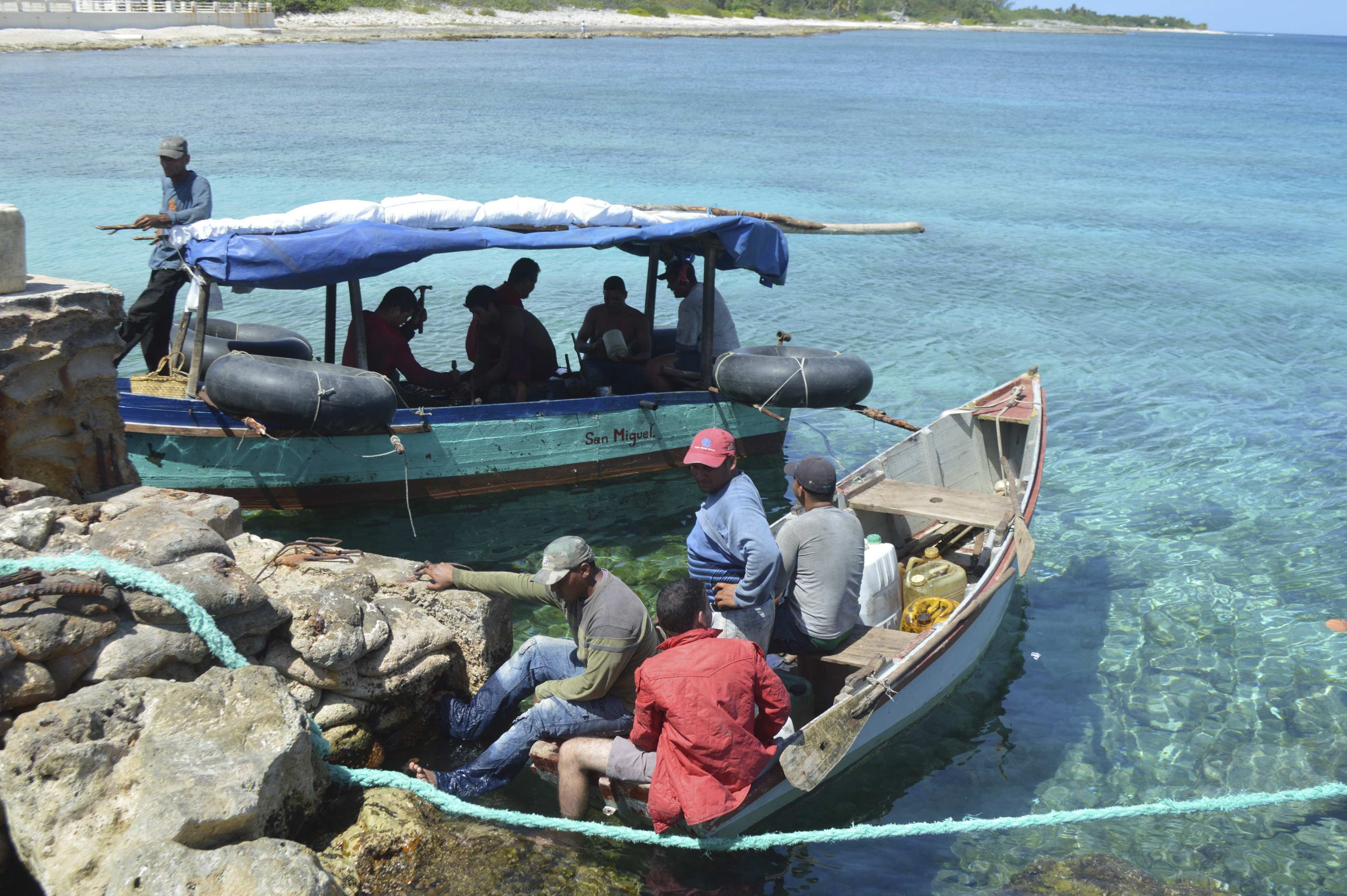 Two boats with 10 Cuban migrants are pictured anchored in Cayman Brac waters in this handout photo