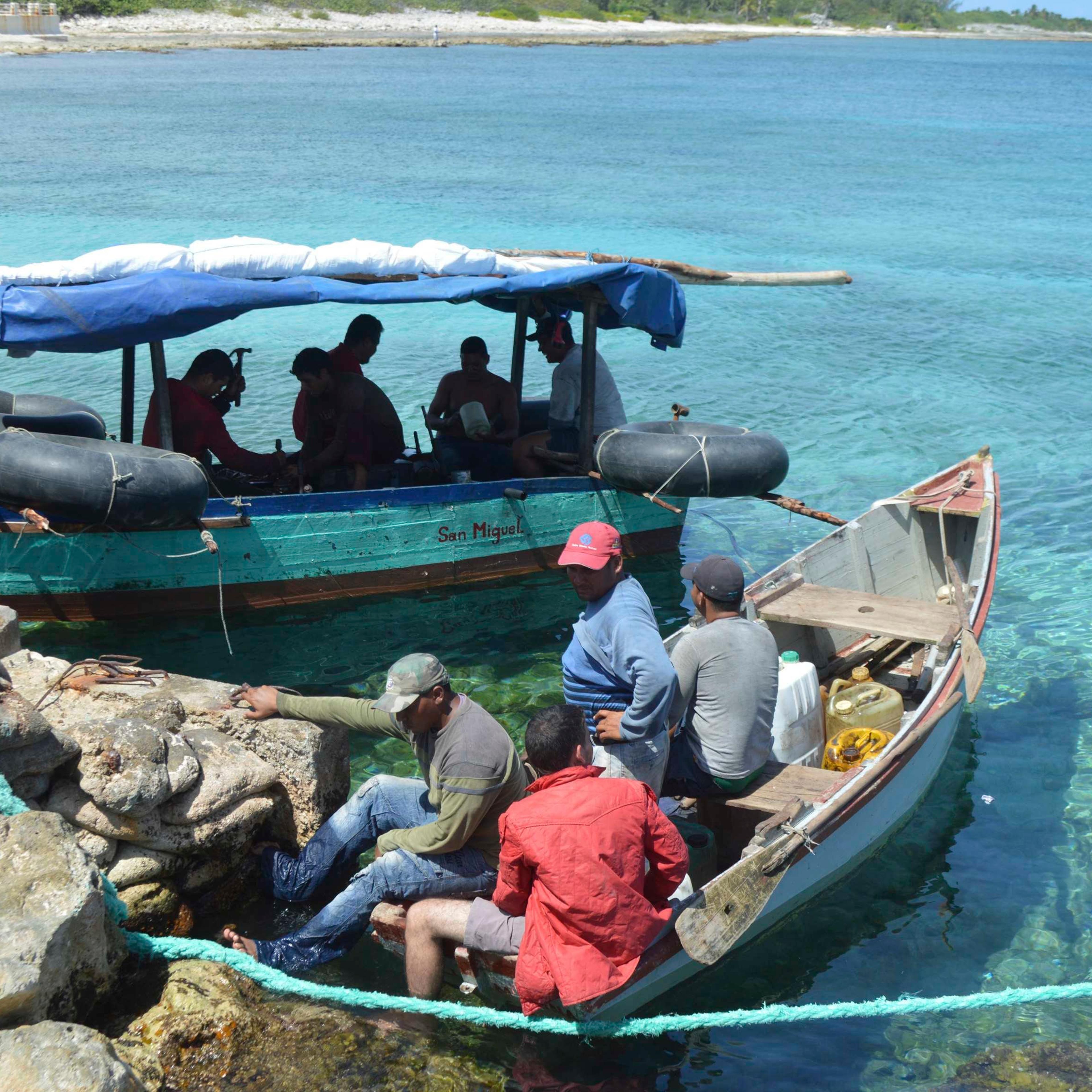 Two boats with 10 Cuban migrants are pictured anchored in Cayman Brac waters in this handout photo