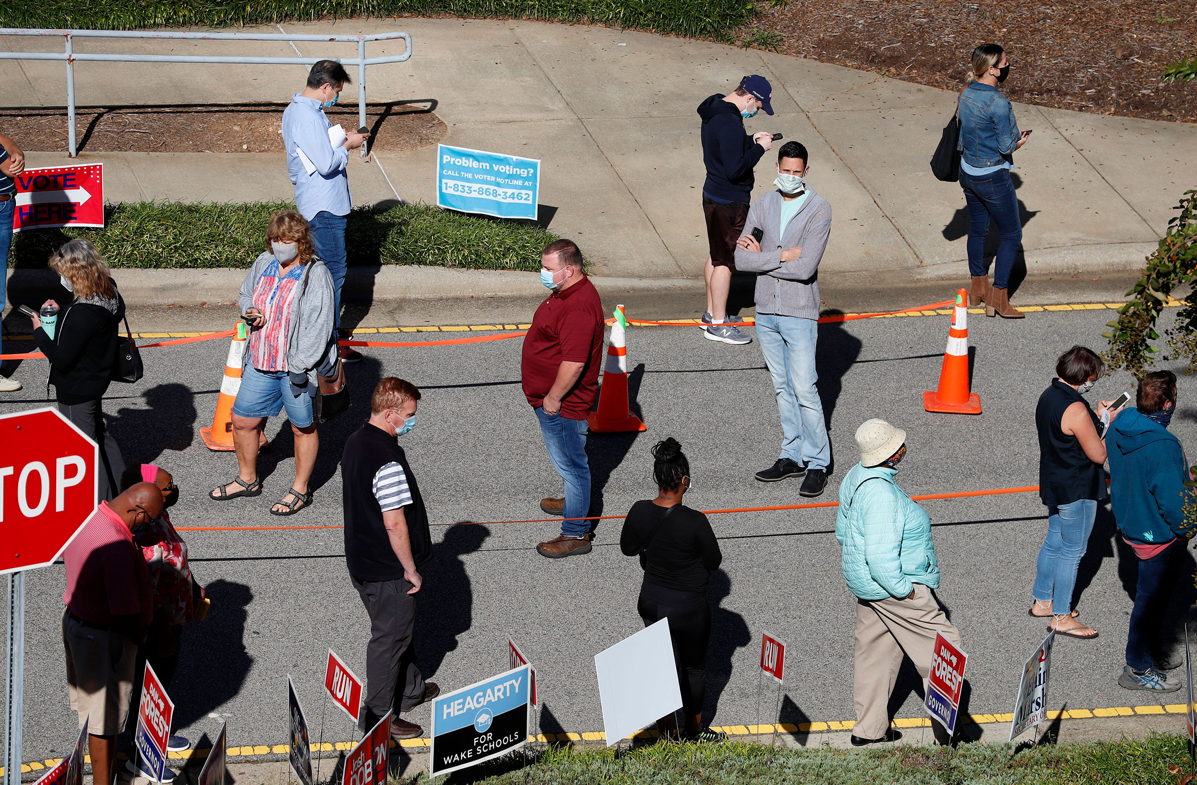 Voters wait in line outside the Herbert C. Young Community Center in Cary, N.C. on the first day of early voting on, Oct. 15, 2020.