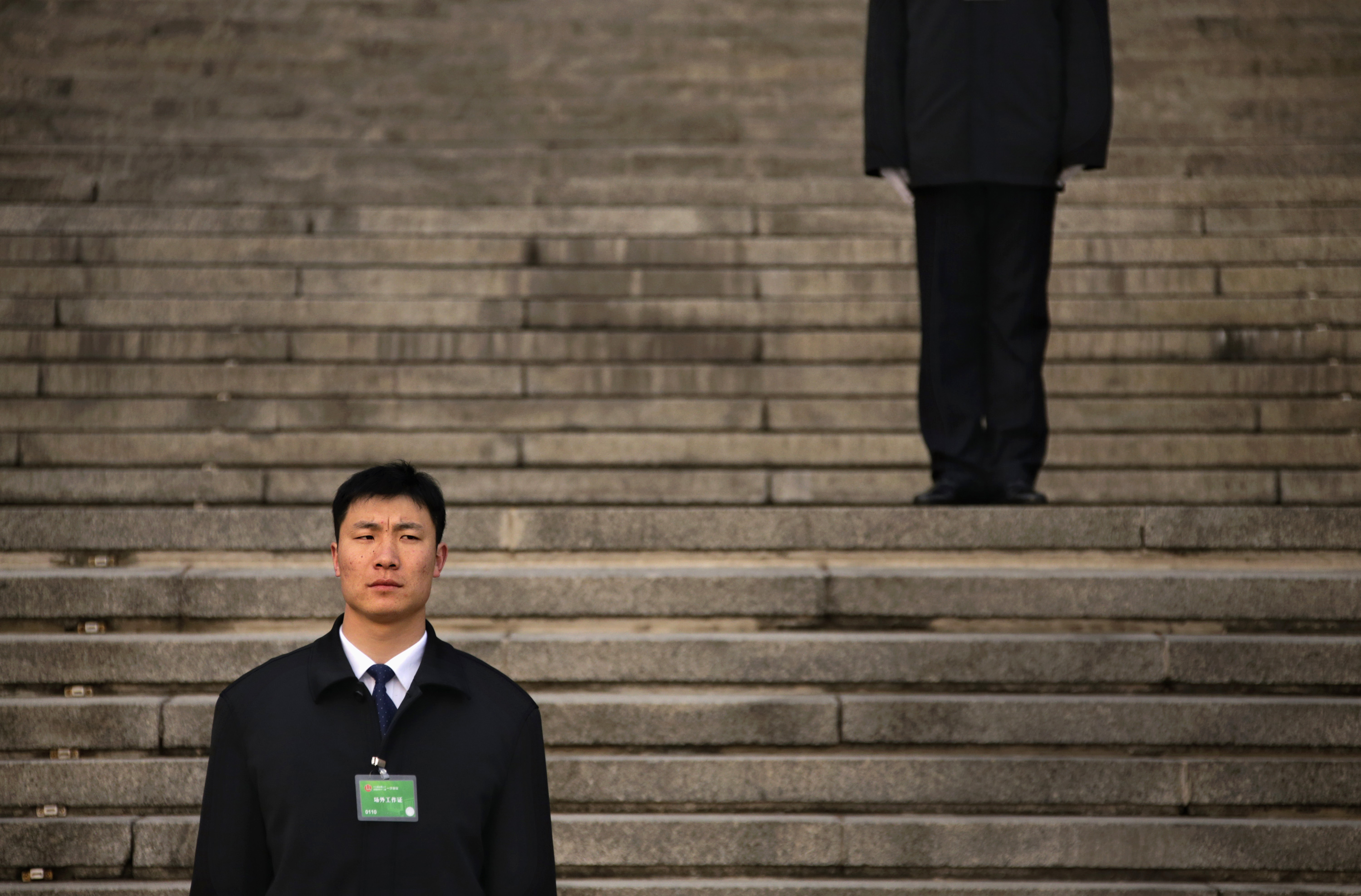 Security personnel stand guard ahead of fifth plenary meeting of National People's Congress in front of Great Hall of People in Beijing