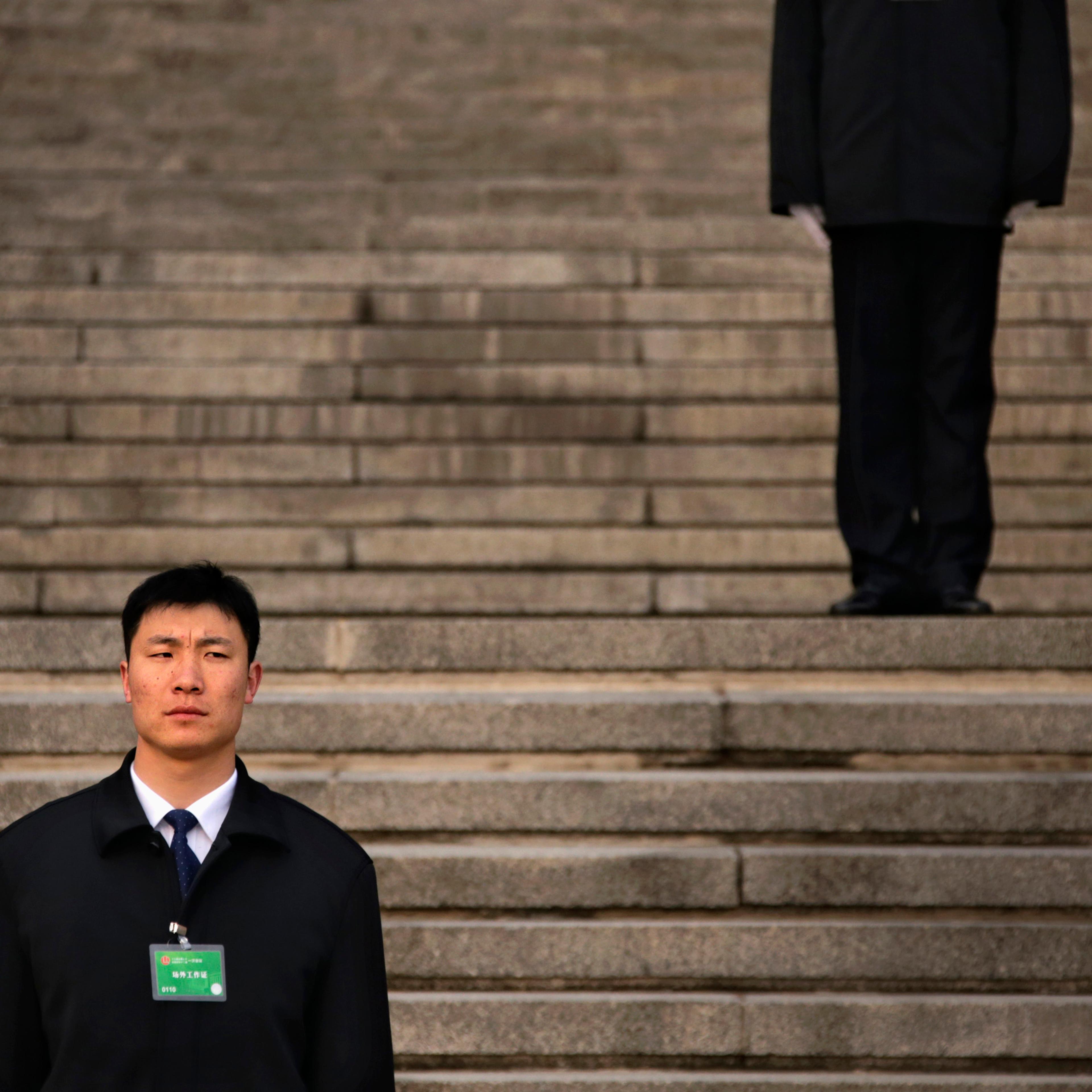 Security personnel stand guard ahead of fifth plenary meeting of National People's Congress in front of Great Hall of People in Beijing