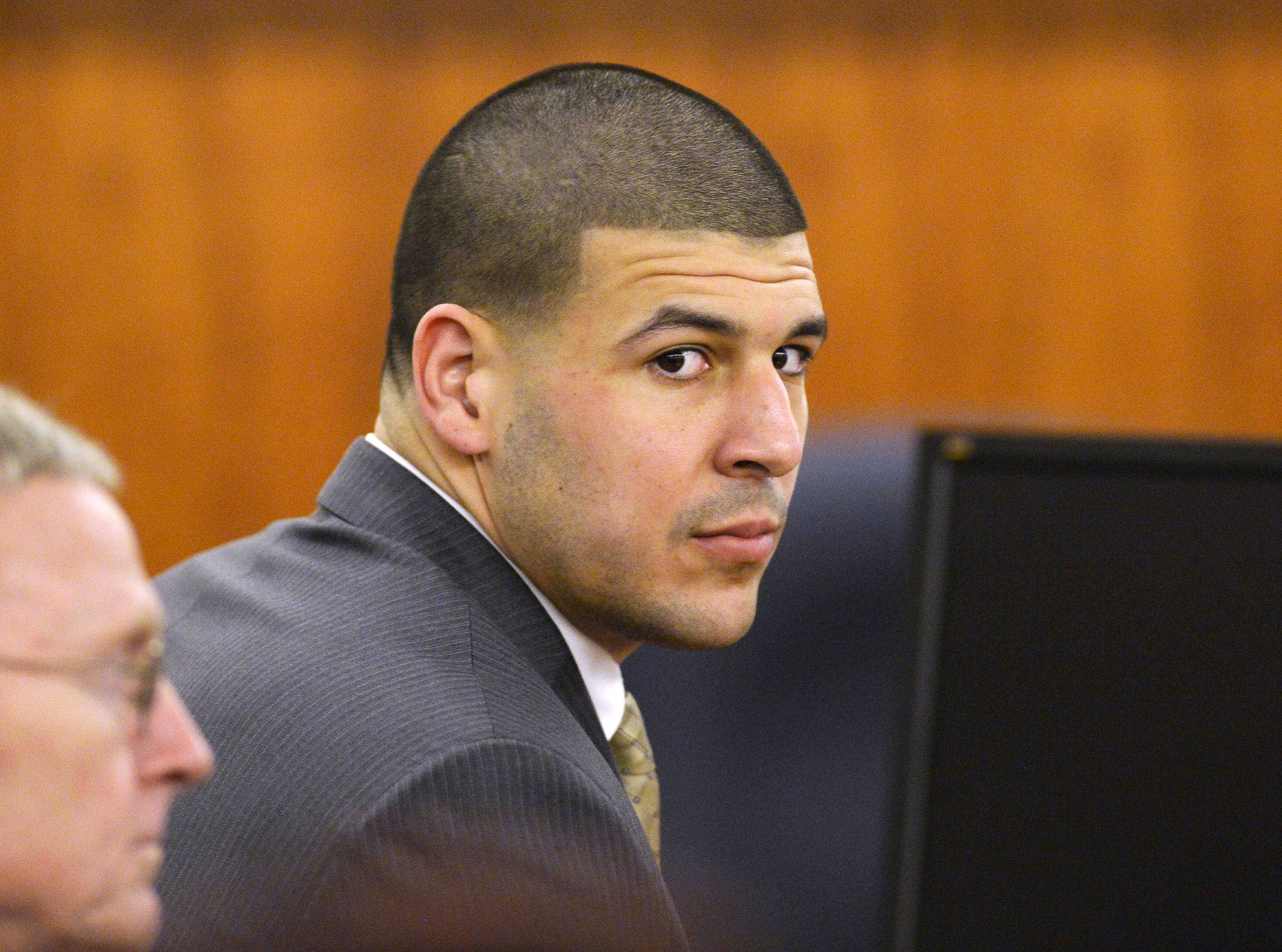 FILE PHOTO: Former NFL player Aaron Hernandez wait in the courtroom in his murder trial at the Bristol County Superior Court in Fall River