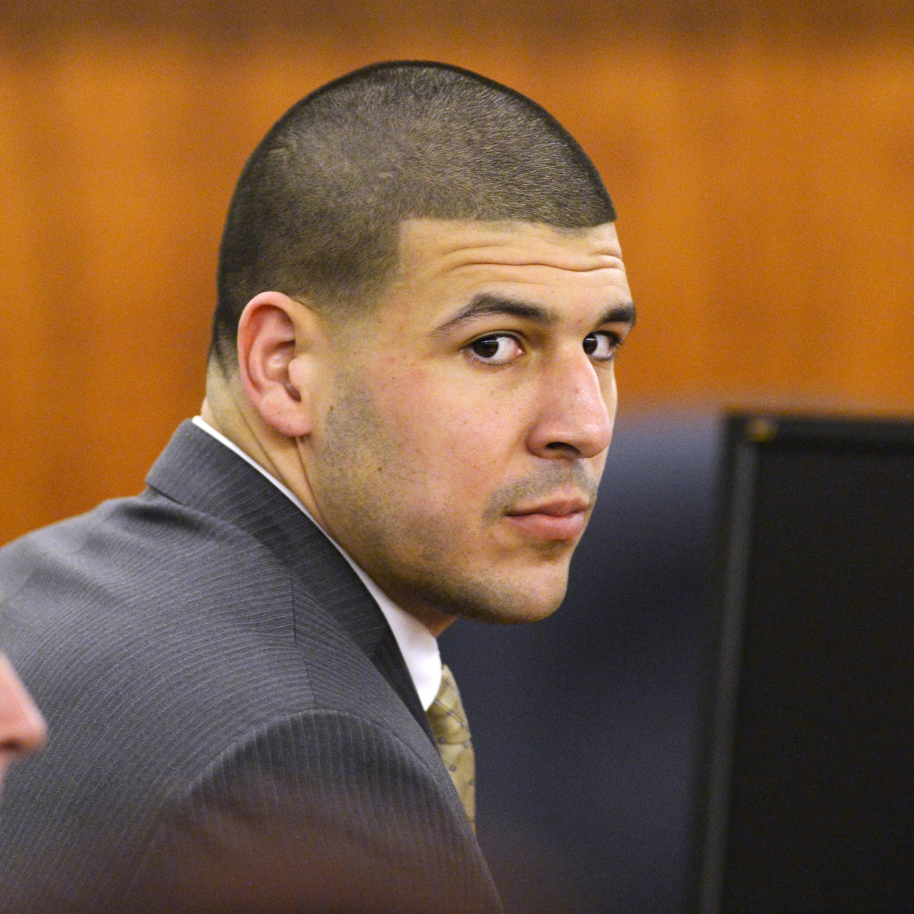 FILE PHOTO: Former NFL player Aaron Hernandez wait in the courtroom in his murder trial at the Bristol County Superior Court in Fall River