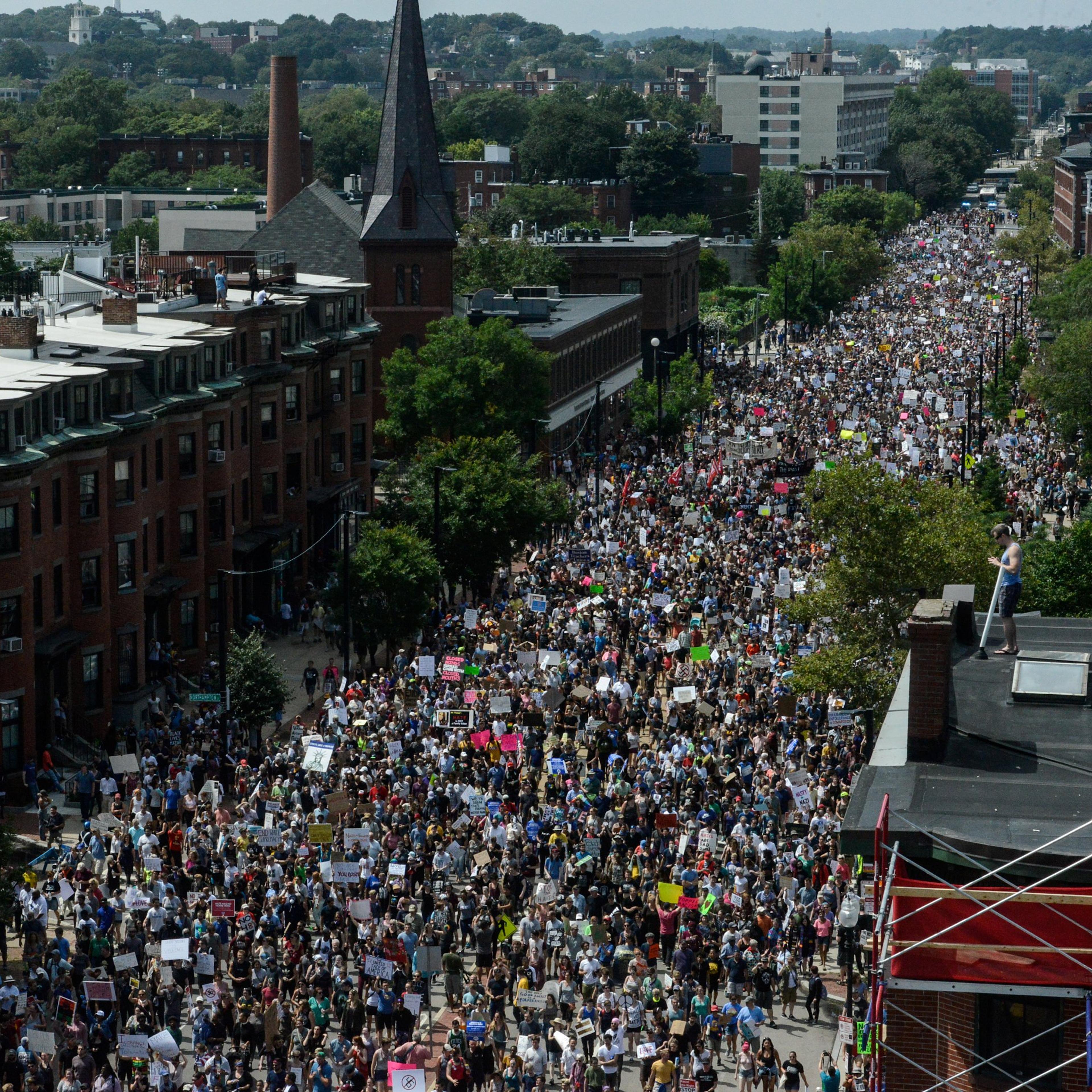 A large crowd of people march towards the Boston Commons to protest the Boston Free Speech Rally in Boston, MA