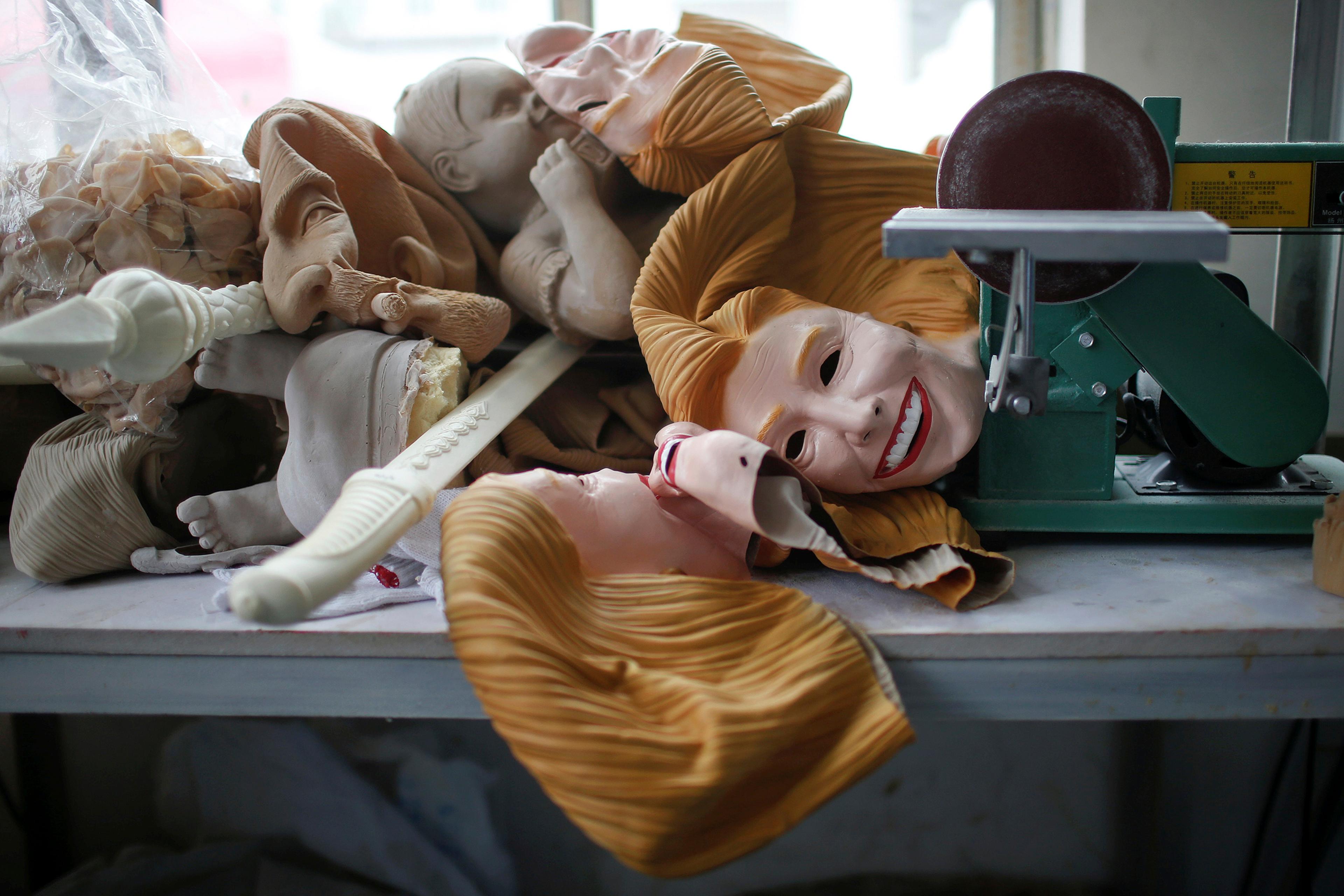 Masks, including some of Democratic presidential candidate Hillary Clinton, are seen at Jinhua Partytime Latex Art and Crafts Factory in Jinhua, Zhejiang Province, China, May 25, 2016.