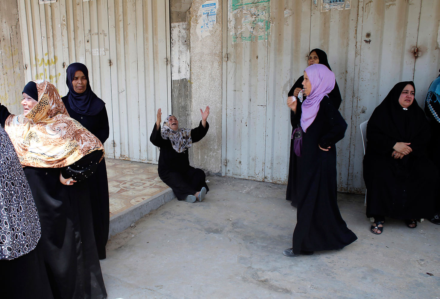 Relatives of three Palestinians from Abu Muamar family, who medics said were killed in an Israeli air strike, mourn during their funeral in Rafah in the southern Gaza Strip