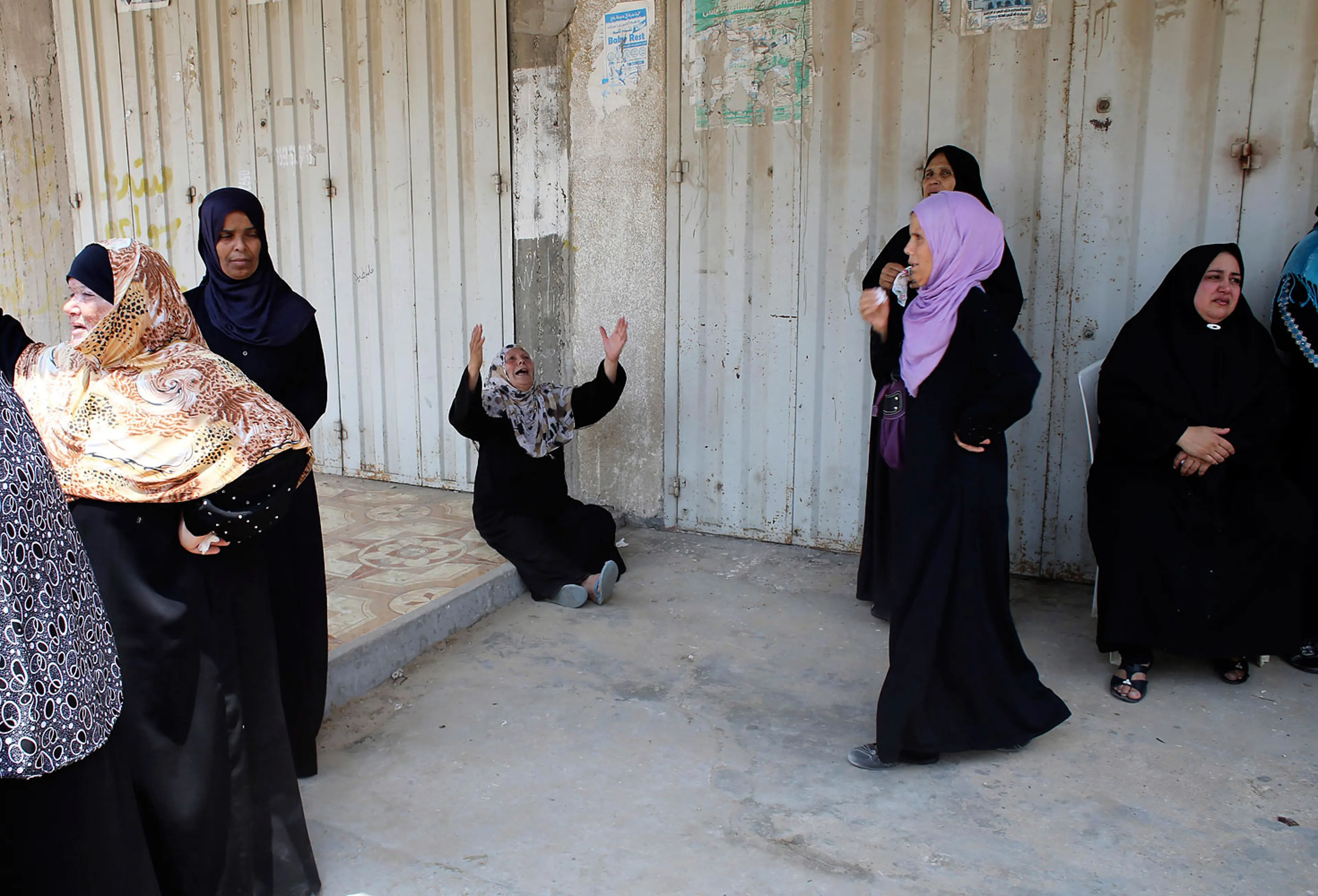 Relatives of three Palestinians from Abu Muamar family, who medics said were killed in an Israeli air strike, mourn during their funeral in Rafah in the southern Gaza Strip