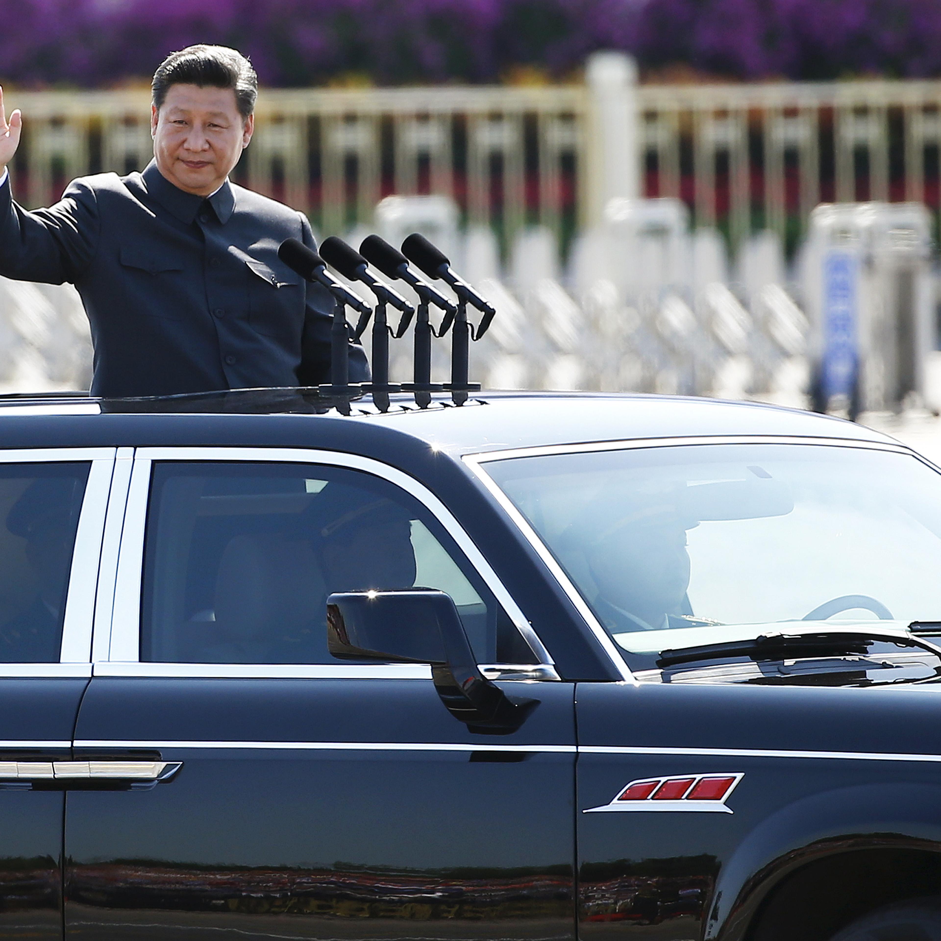 Chinese President Xi Jinping waves as he reviews the army, at the beginning of the military parade marking the 70th anniversary of the end of World War Two, in Beijing
