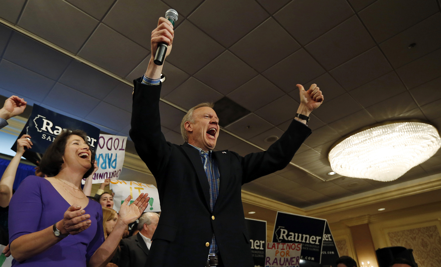 Republican candidate for Illinois Governor Bruce Rauner celebrates with his wife Diana after winning the nomination in the Illinois Primary in Chicago