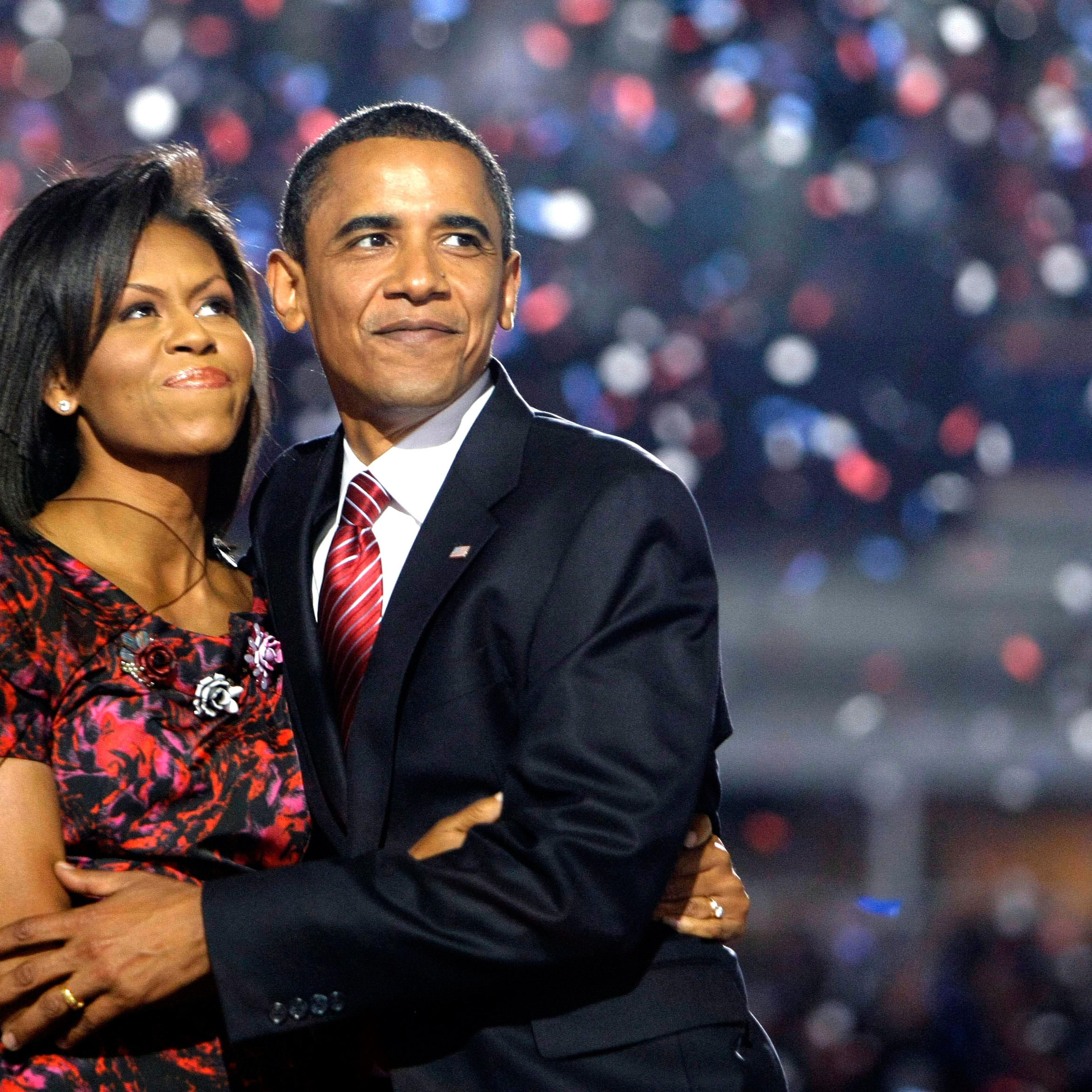 Barack Obama, hugs Michelle Obama after giving his acceptance speech at the Democratic National Convention at Invesco Field at Mile High in Denver, Aug. 28, 2008.