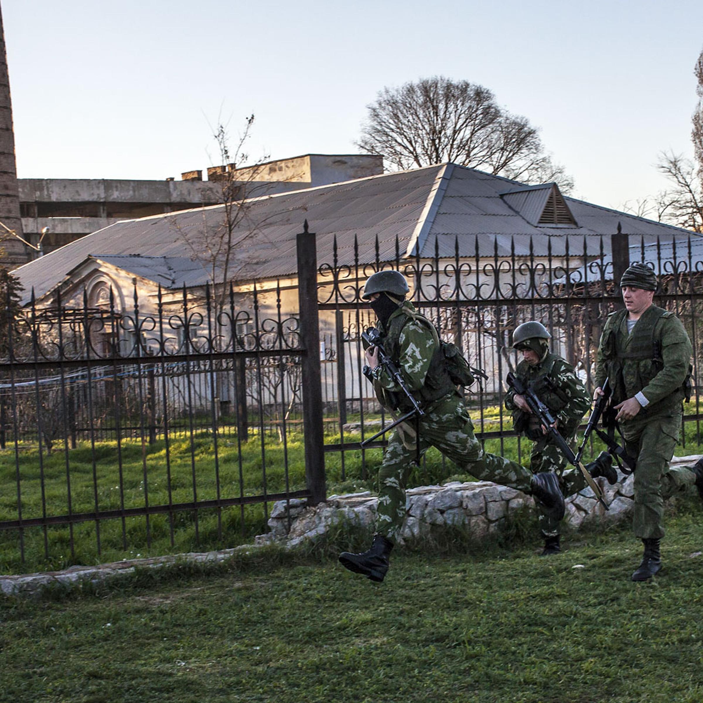Russian forces storm a Ukrainian military base in the village of Belbek, Crimea.