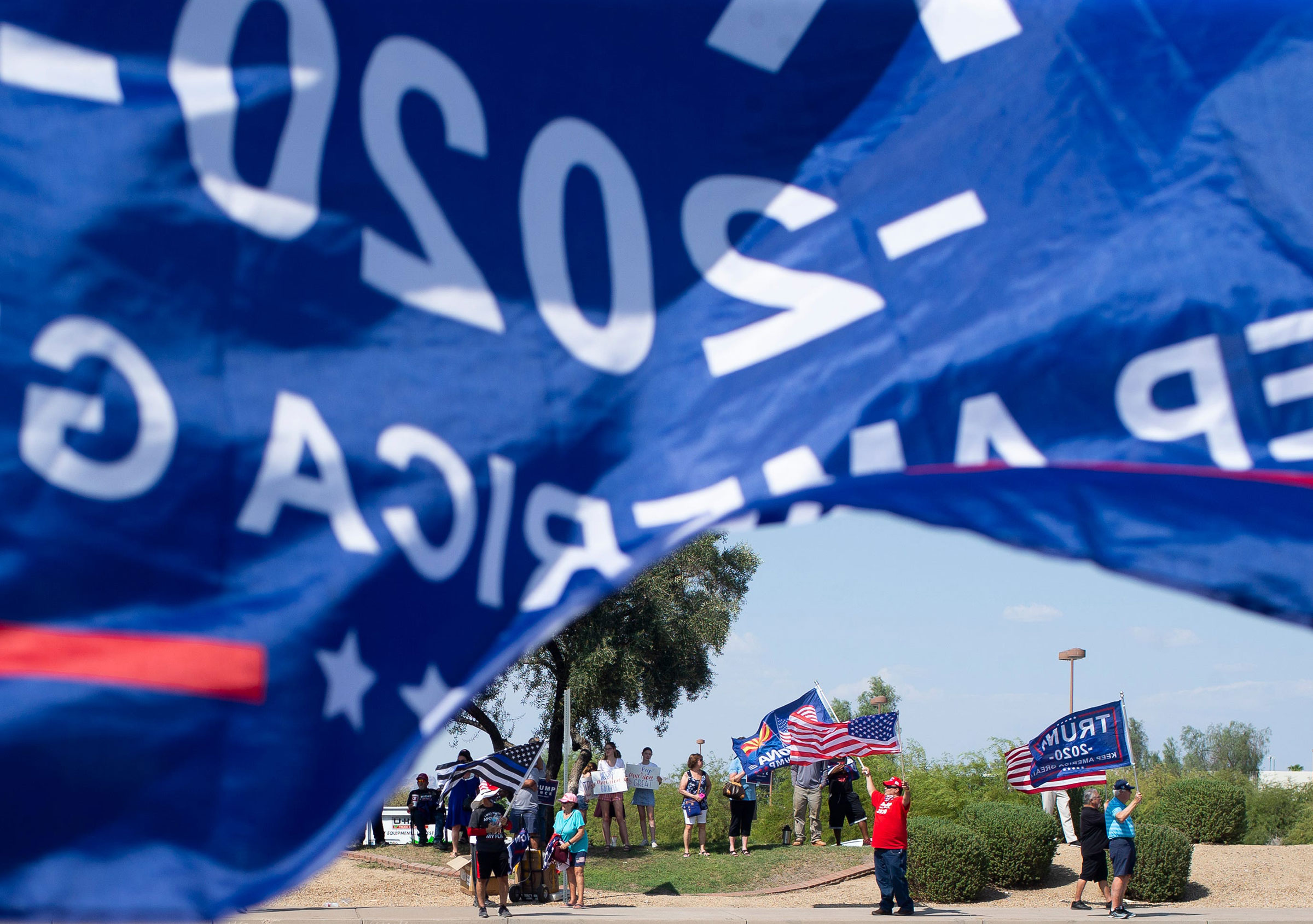 Supporters of President Donald Trump wait in line at the Arizona Grand Resort to hear the President speak at a "Latinos for Trump" roundtable in Phoenix
