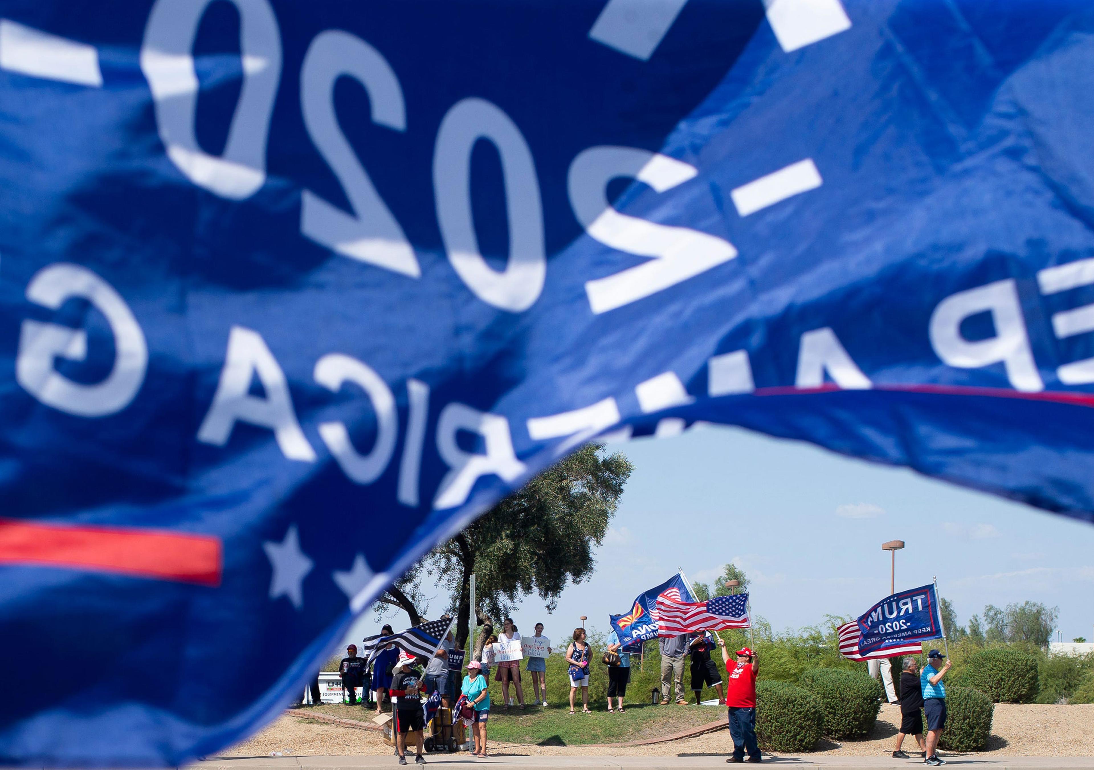 Supporters of President Donald Trump wait in line at the Arizona Grand Resort to hear the President speak at a "Latinos for Trump" roundtable in Phoenix
