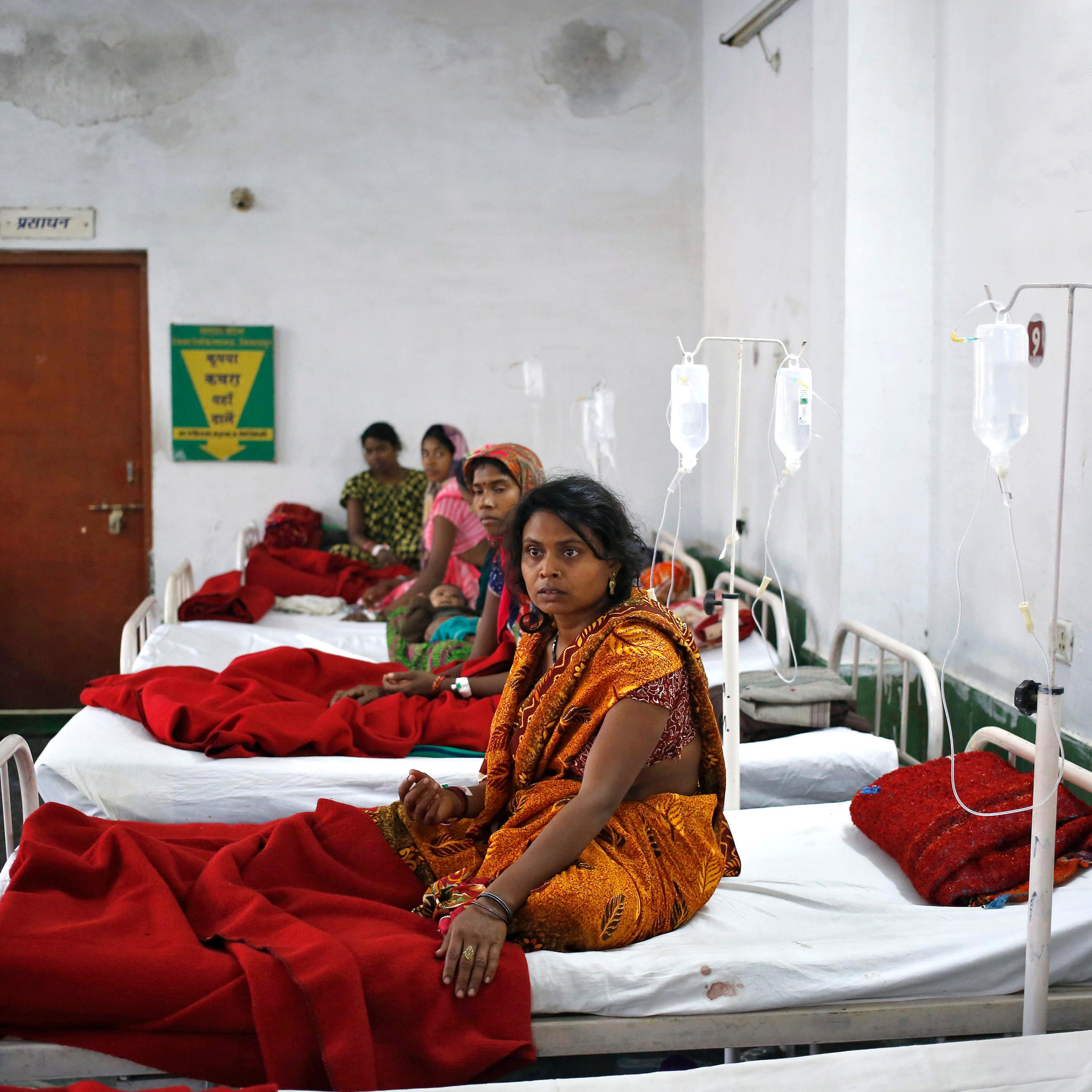 Women, who underwent a sterilization surgery at a government mass sterilisation "camp", lie in hospital beds for treatment at CIMS hospital in Bilaspur