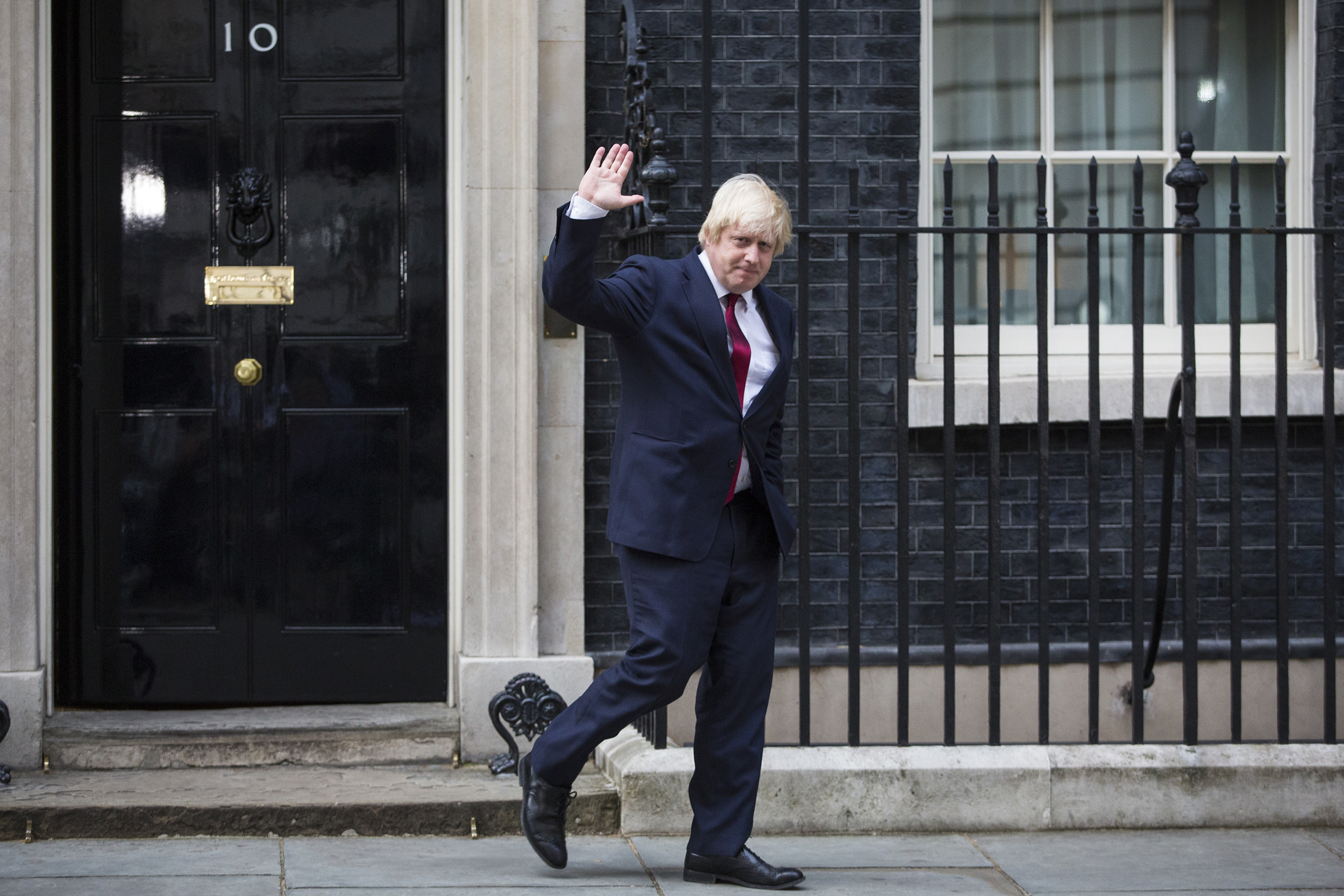 Boris Johnson waves as he leaves Downing Street after being appointed Foreign Secretary in London, July 13, 2016.