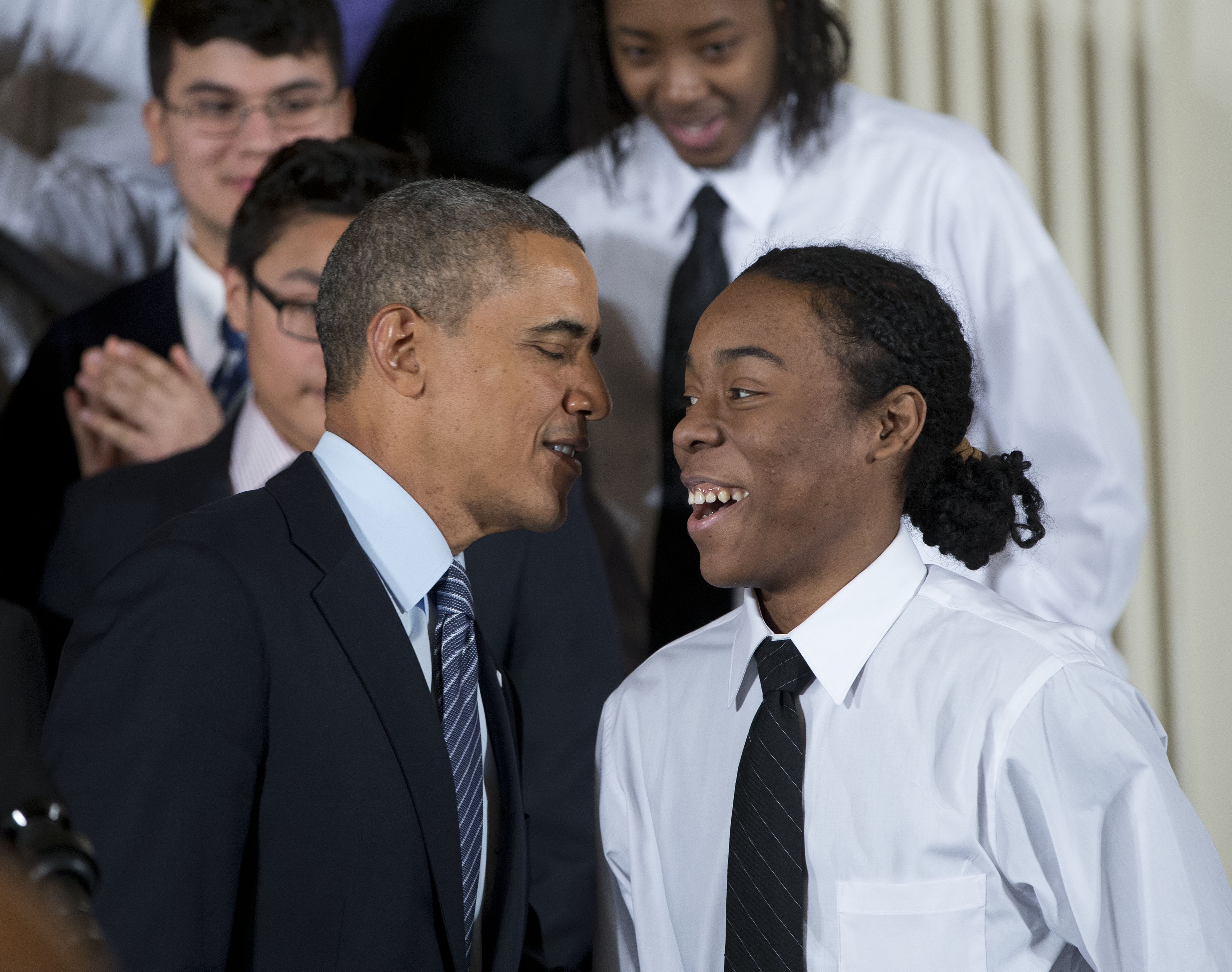 President Barack Obama speaks with Christian Champagne, 18, a senior at Hyde Park Career Academy in Chicago, who introduced him before launching a new initiative to provide greater opportunities for young black and Hispanic men called 'My Brother's Keepe