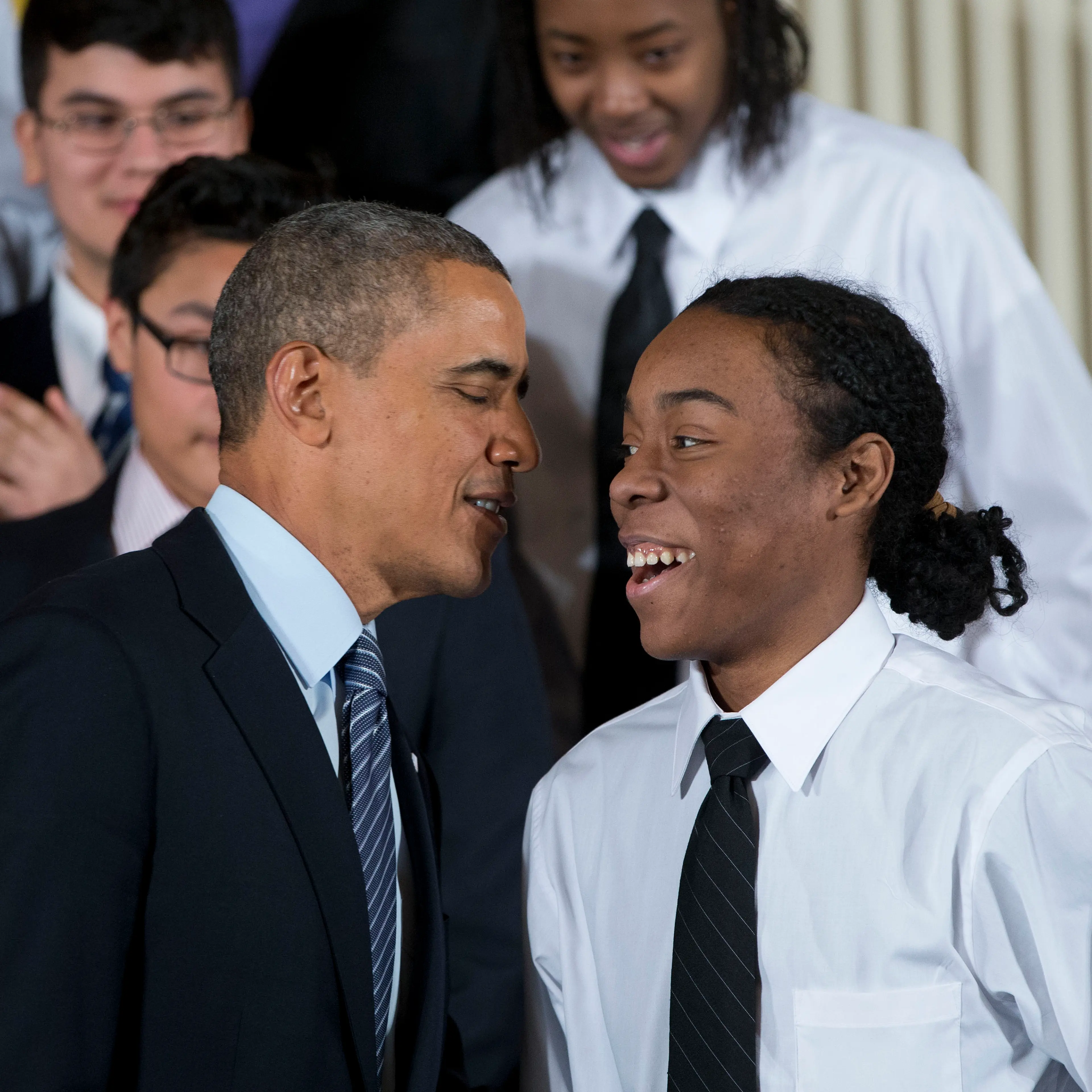 President Barack Obama speaks with Christian Champagne, 18, a senior at Hyde Park Career Academy in Chicago, who introduced him before launching a new initiative to provide greater opportunities for young black and Hispanic men called 'My Brother's Keepe