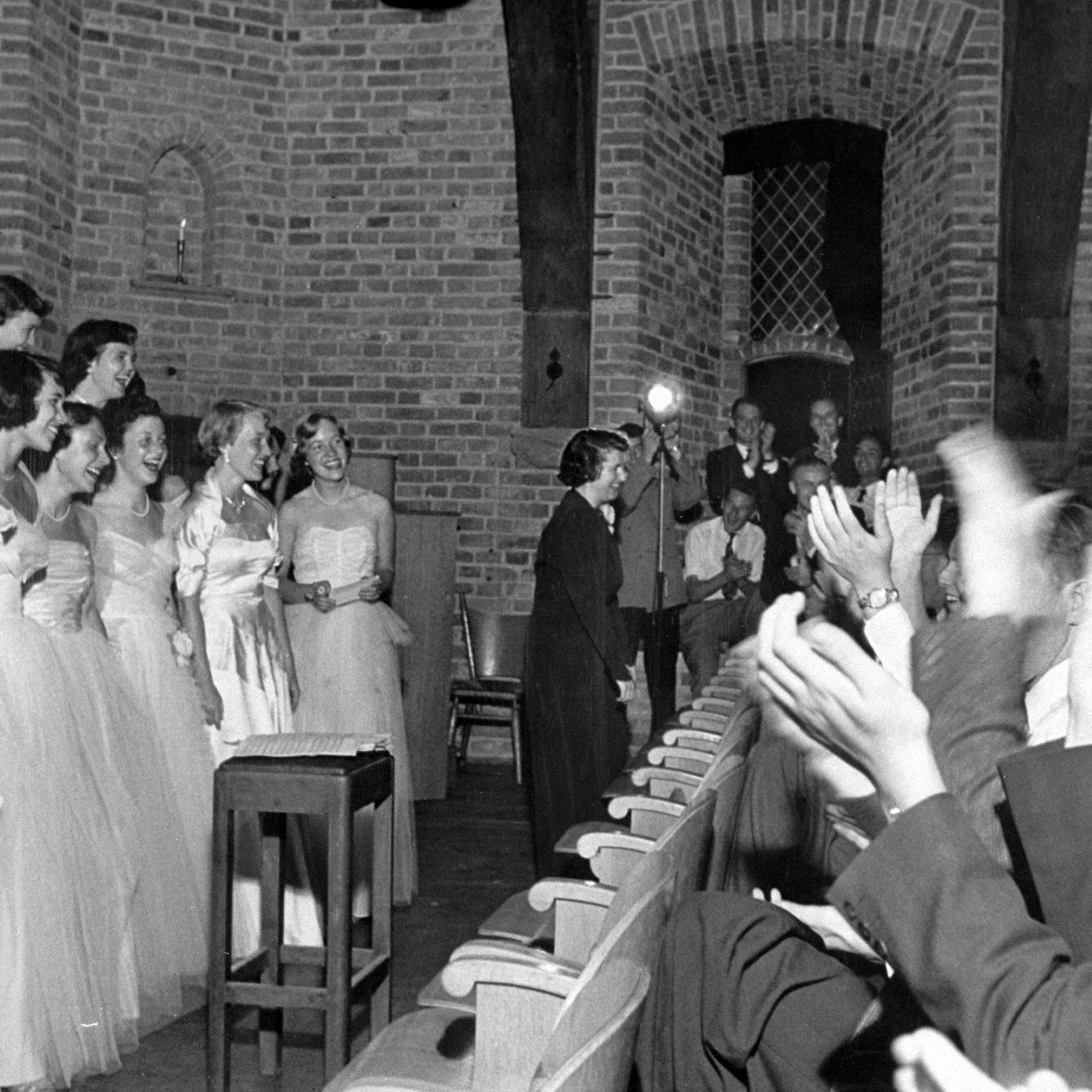 Dressed in white evening gowns, The Smith Singers get a tremendous ovation following a concert in weapons room of Dutch castle at Breukelen, namesake of New York's Brooklyn.