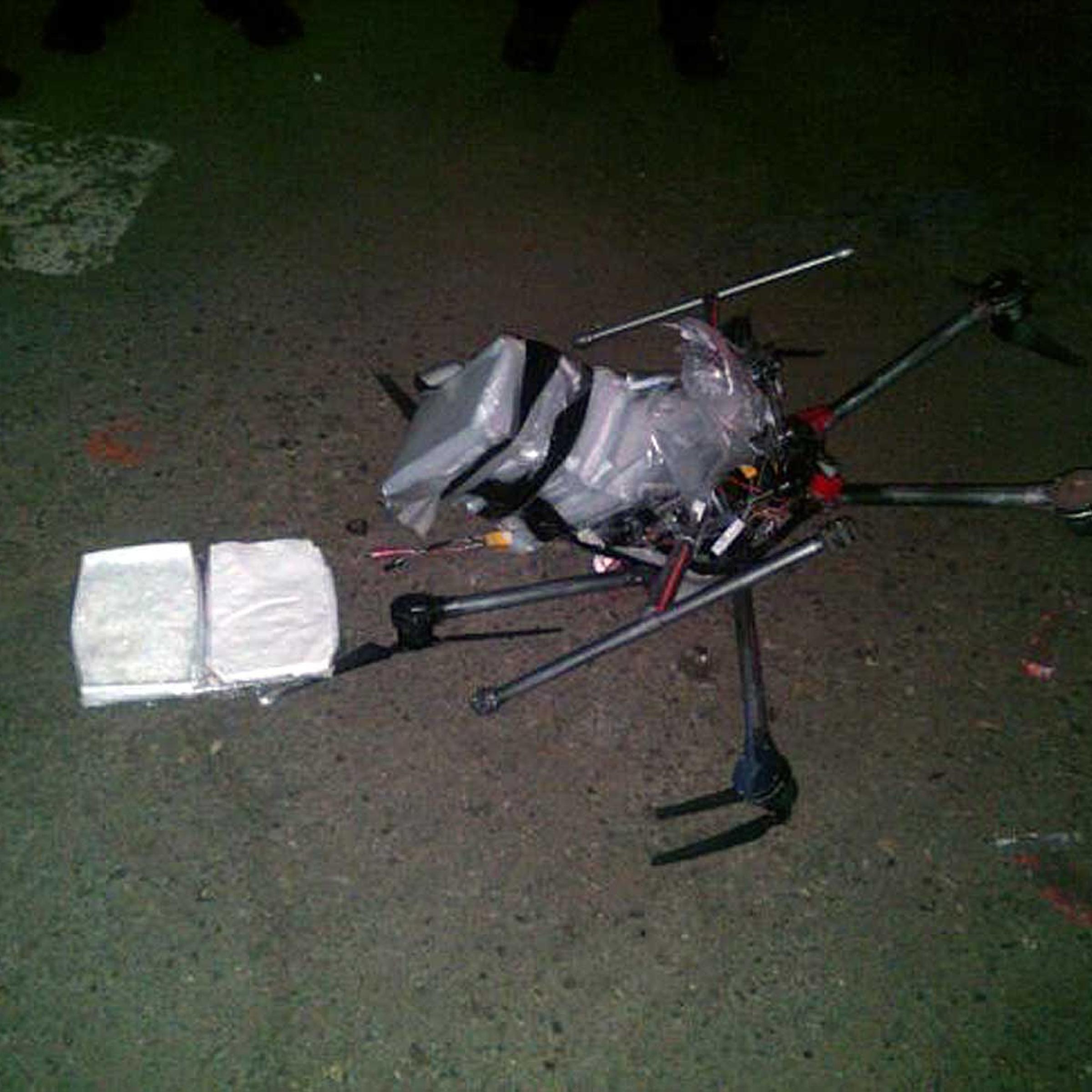 A drone loaded with packages containing methamphetamine lies on the ground after it crashed into a supermarket parking lot in the city of Tijuana on Jan. 20, 2015.