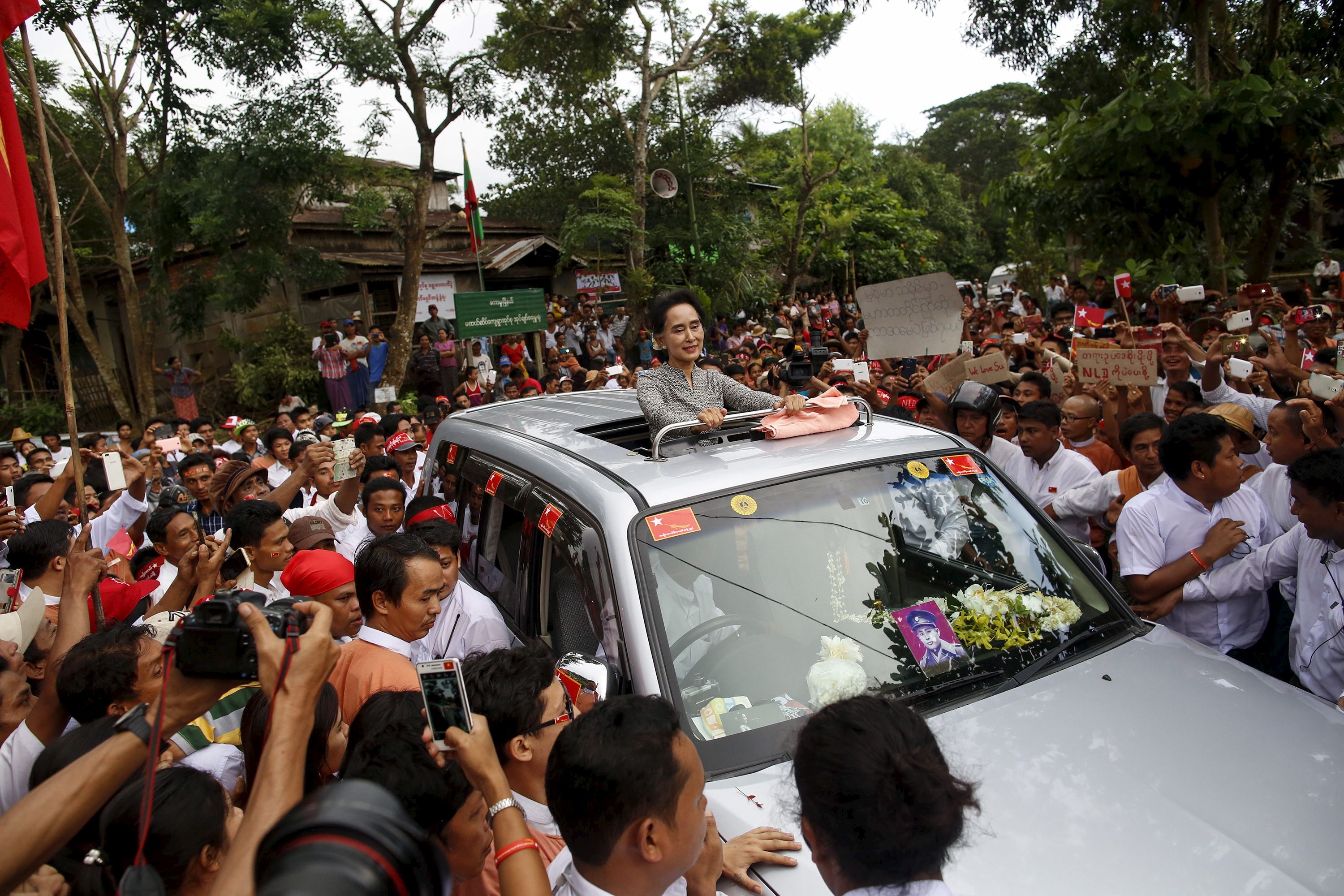 Myanmar pro-democracy leader Aung San Suu Ky smiles as she greets her supporters during her campaign in her constituency of Kawhmu township outside Yangon