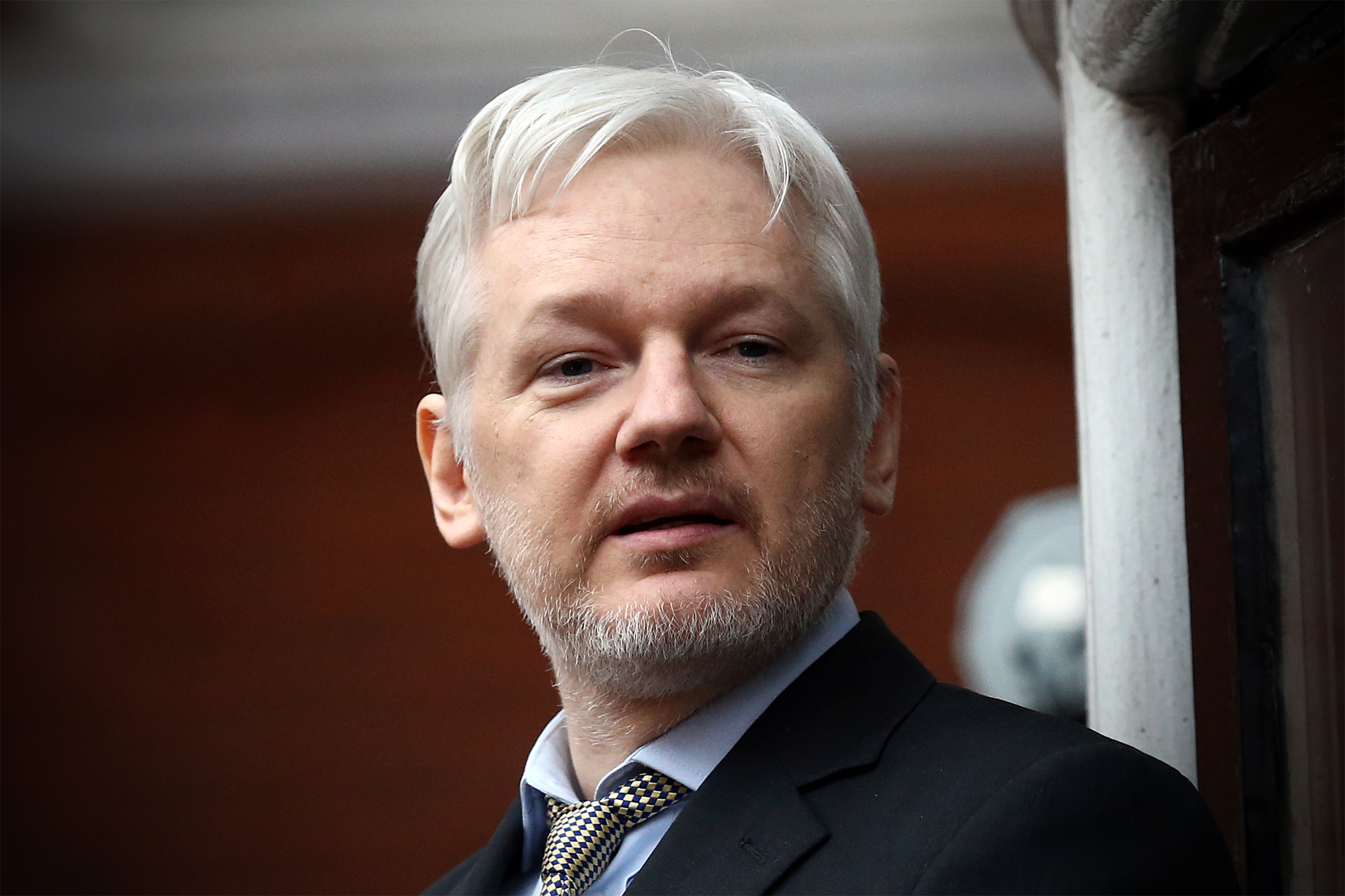 Wikileaks founder Julian Assange speaks from the balcony of the Ecuadorian embassy where he continues to seek asylum following an extradition request from Sweden in 2012, on February 5, 2016 in London, England.
