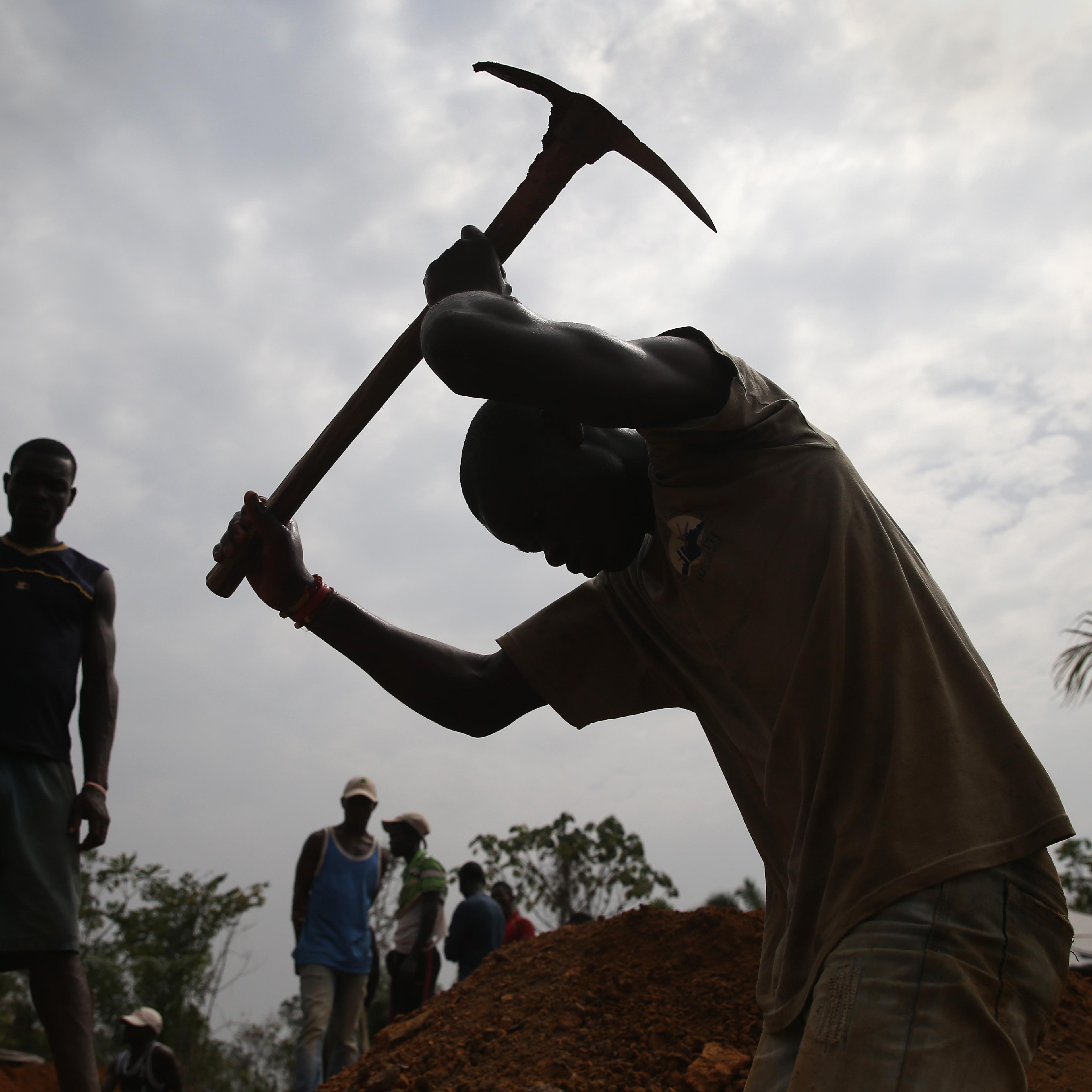 A grave digger works in the U.S.-built cemetery for "safe burials" on Jan. 27, 2015 in Disco Hill, Liberia.