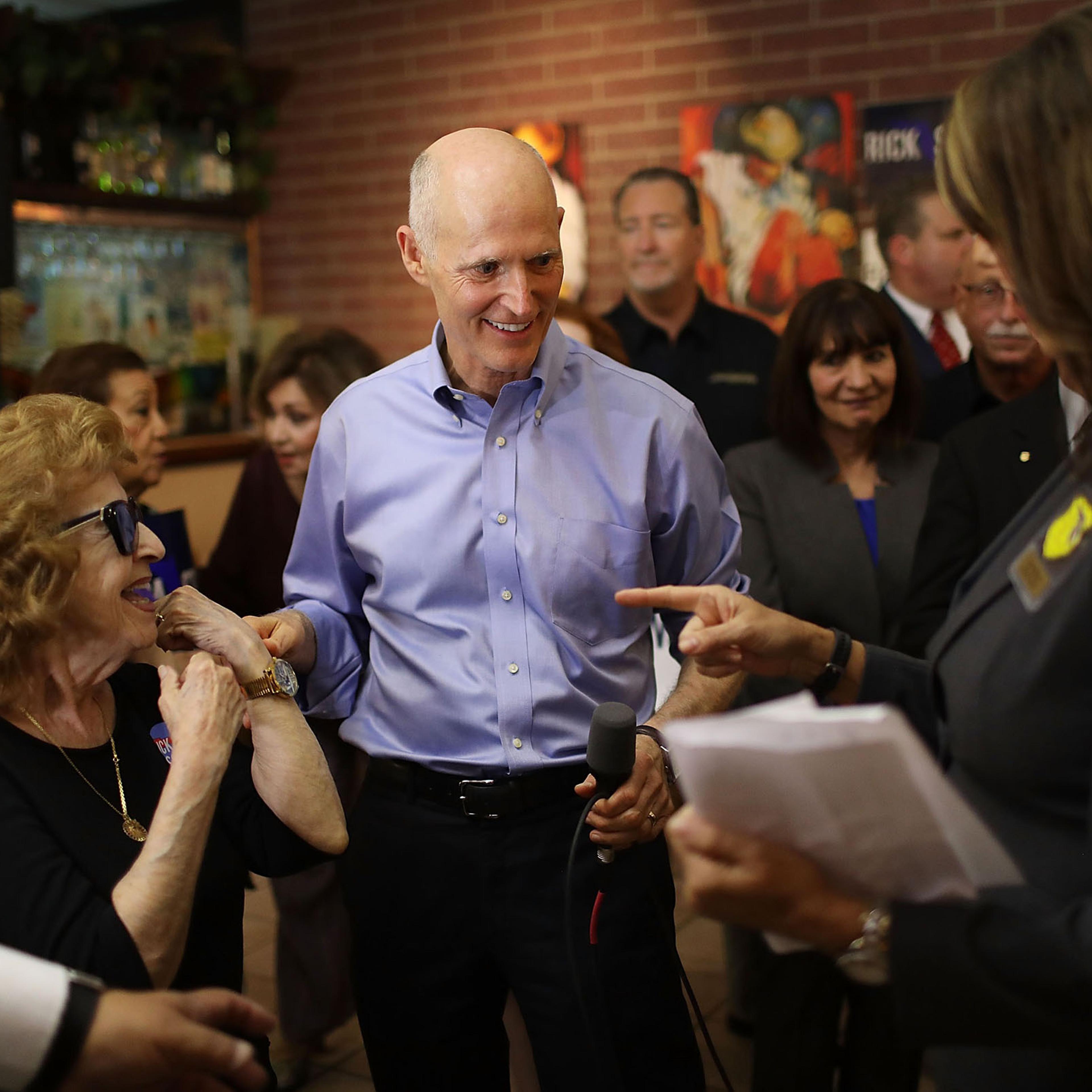 Scott greets voters on June 14 during a campaign stop at Chico’s Restaurant in Hialeah, Fla.