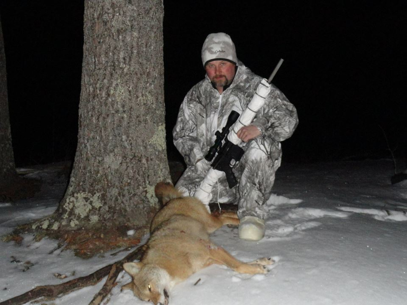 George Sodergren poses with a coyote he killed with his AR-15 in Maine. 