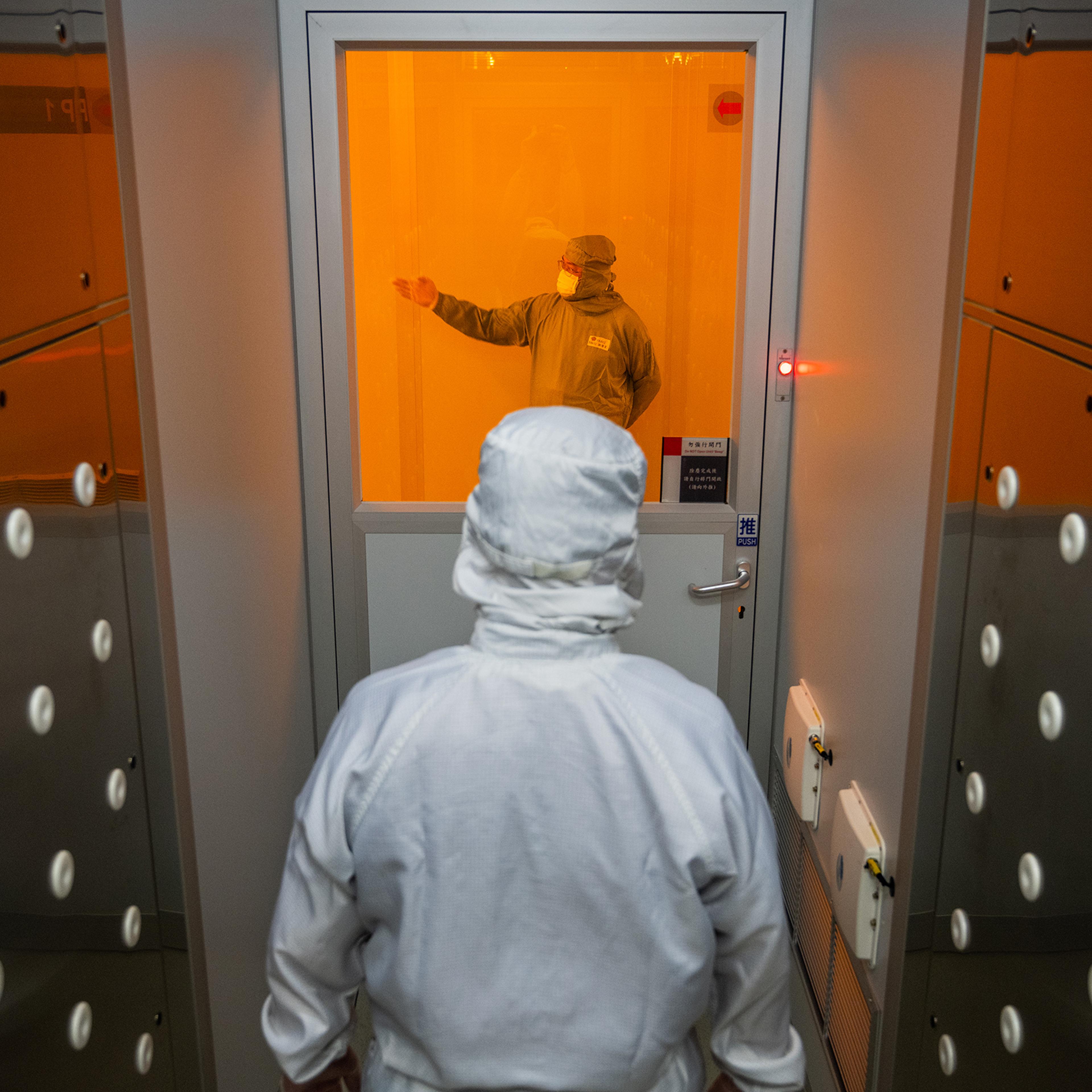 A worker enters a “clean room” at chipmaker TSMC’s headquarters in Hsinchu, Taiwan, on Sept. 10