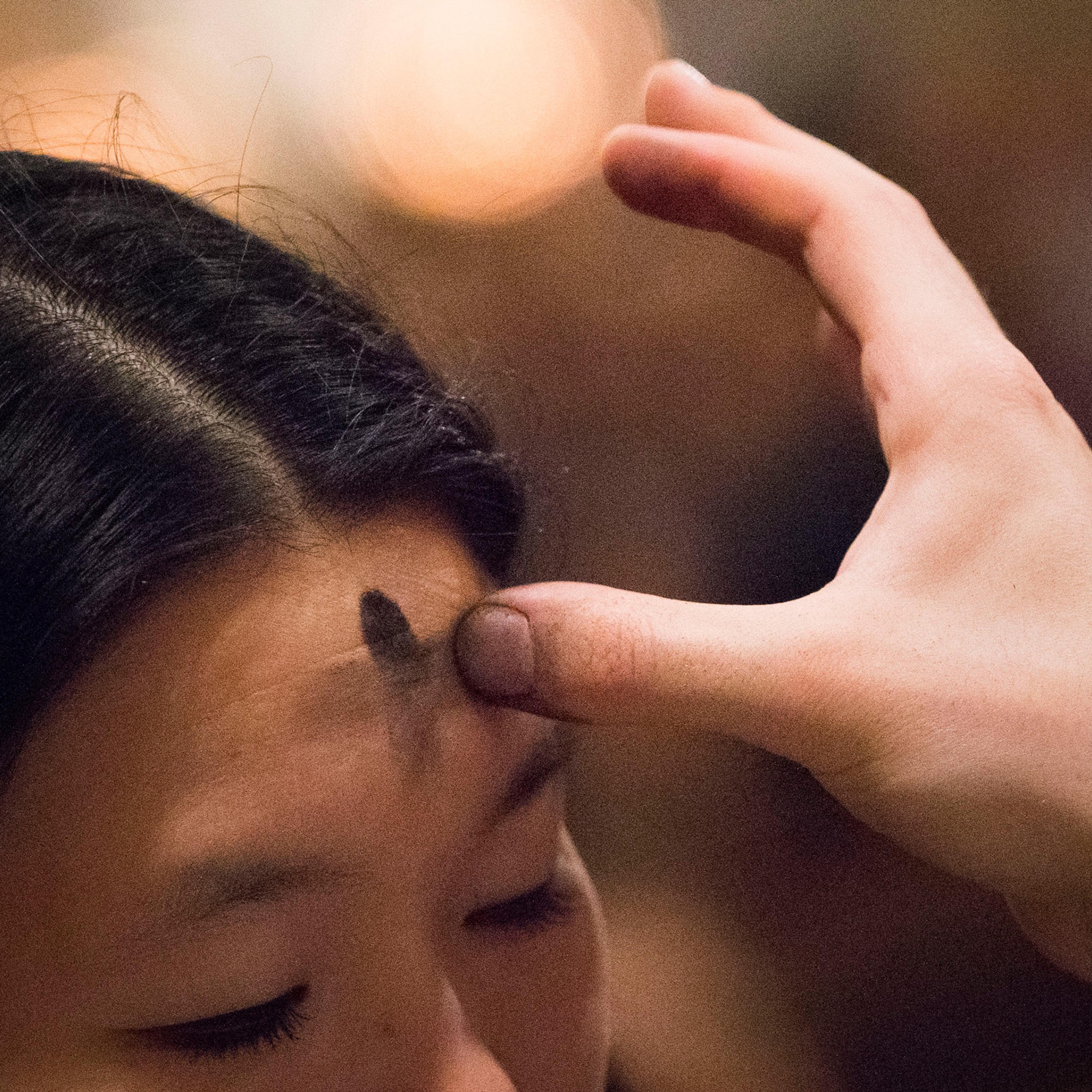 A woman receives ashes at Saint Patrick's Cathedral on Ash Wednesday in New York February 13, 2013. REUTERS/Adrees Latif (UNITED STATES - Tags: RELIGION ANNIVERSARY) - RTR3DQUC