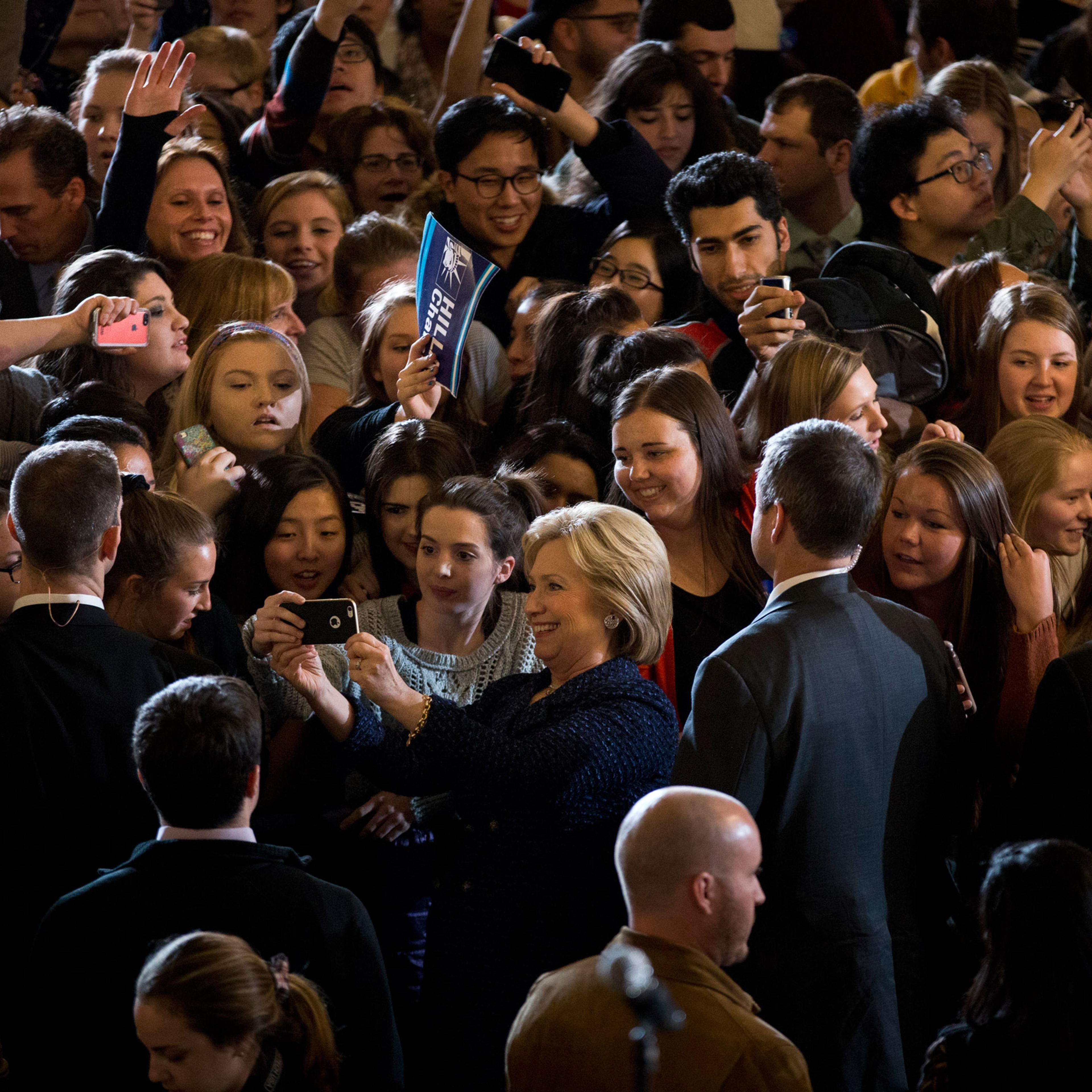 Democratic presidential candidate Hillary Clinton, center, takes a selfie with students during a rally on the campus of University of Iowa Thursday, Jan. 21, 2016, in Iowa City, Iowa. (AP Photo/Jae C. Hong)
